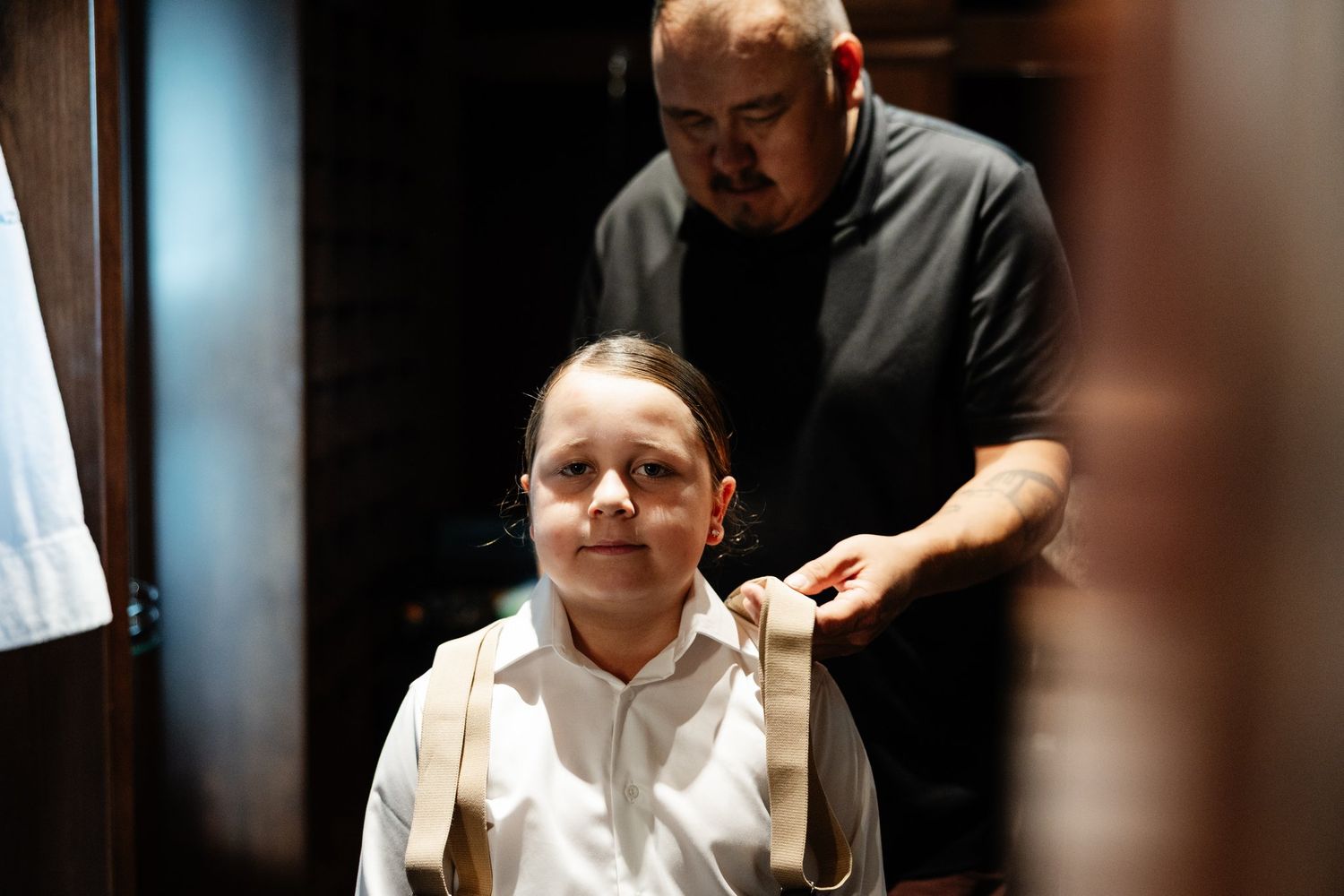 Bride braiding her son's hair before the ceremony, co-best man