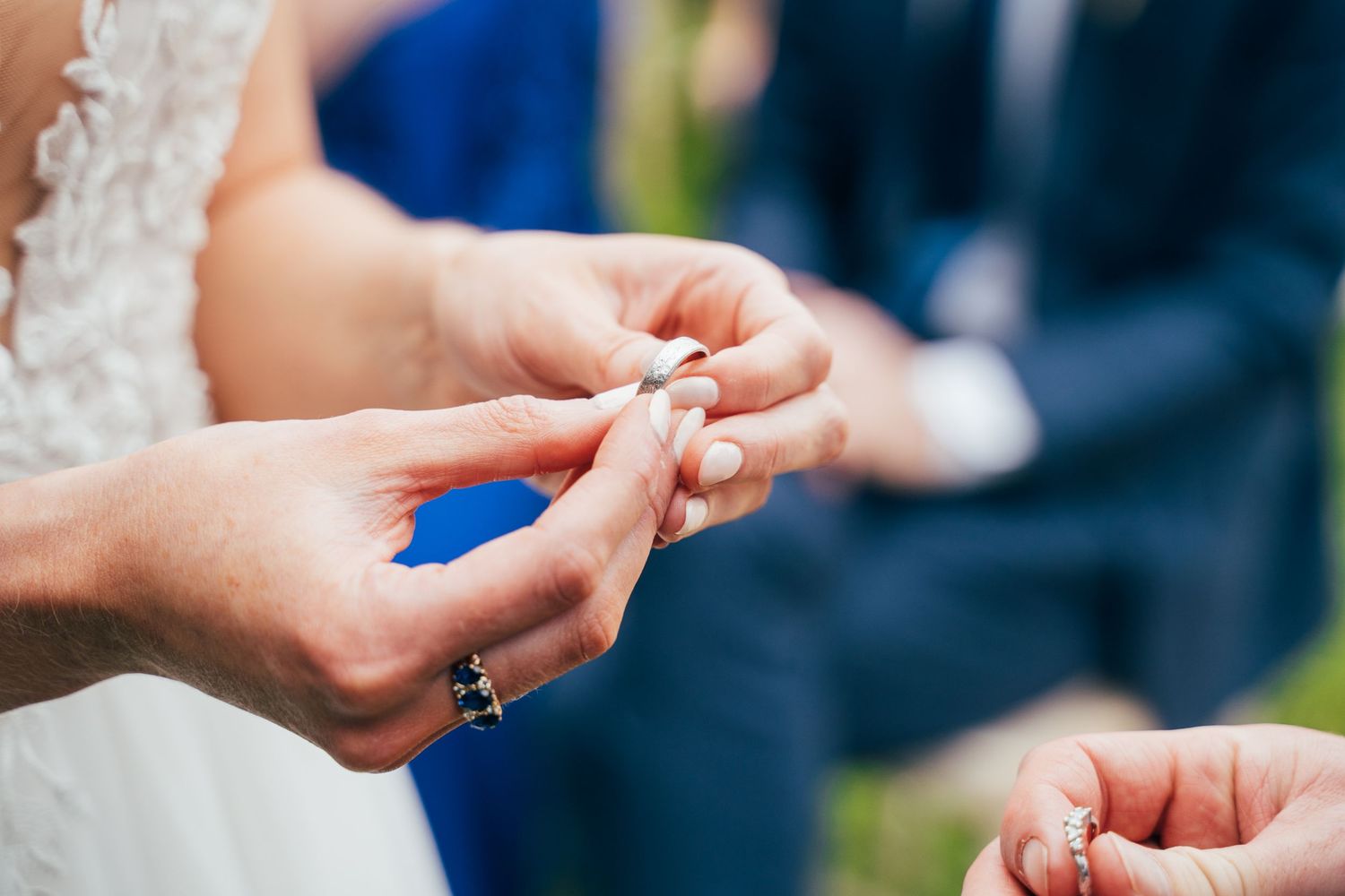 Close-up of a bride and groom exchanging wedding rings during an outdoor ceremony. Under the iconic beech at Bellinter House