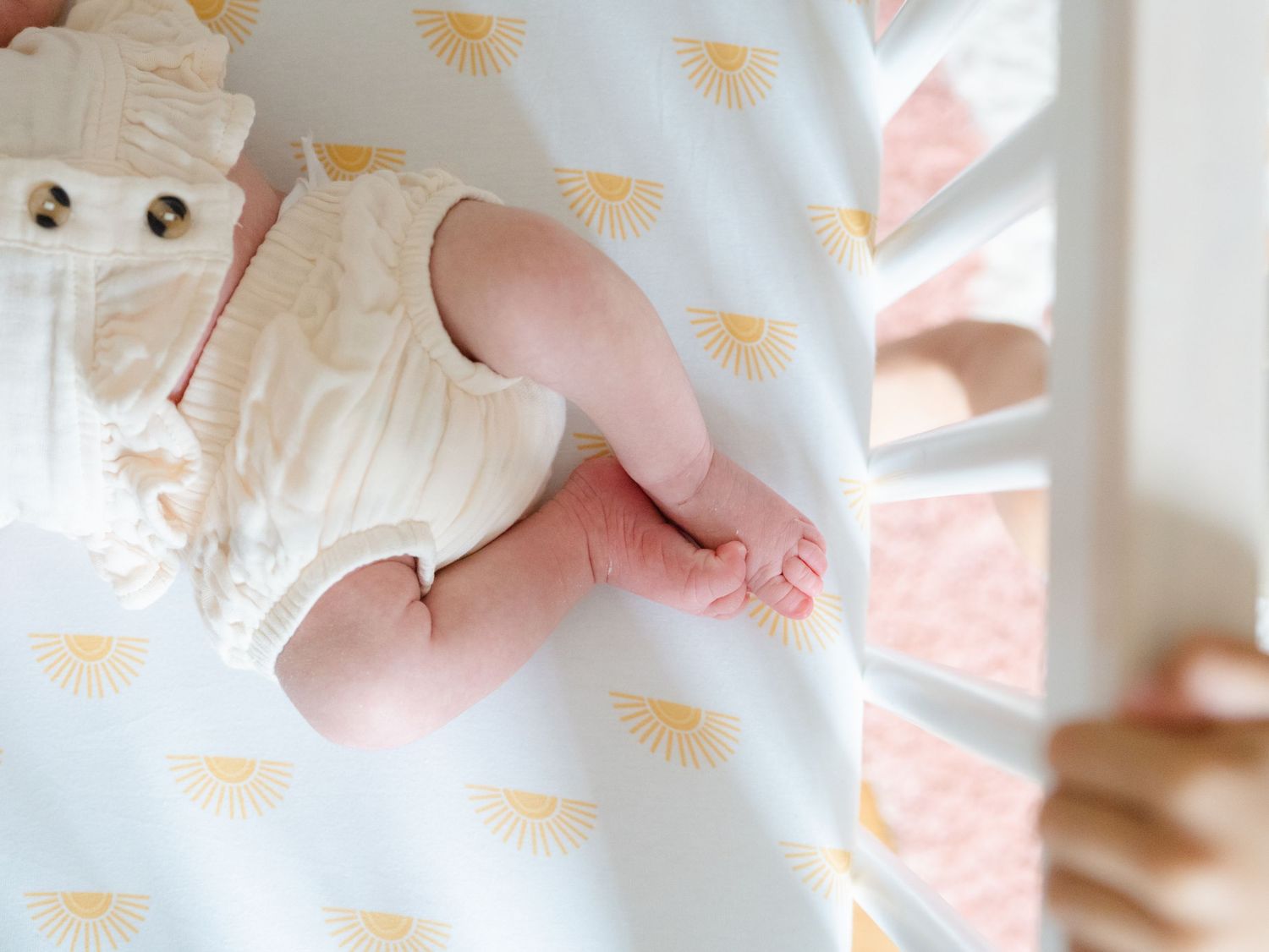 Close up of baby's feet while sleeping in crib during an in home photo session in Point Pleasant Beach NJ.