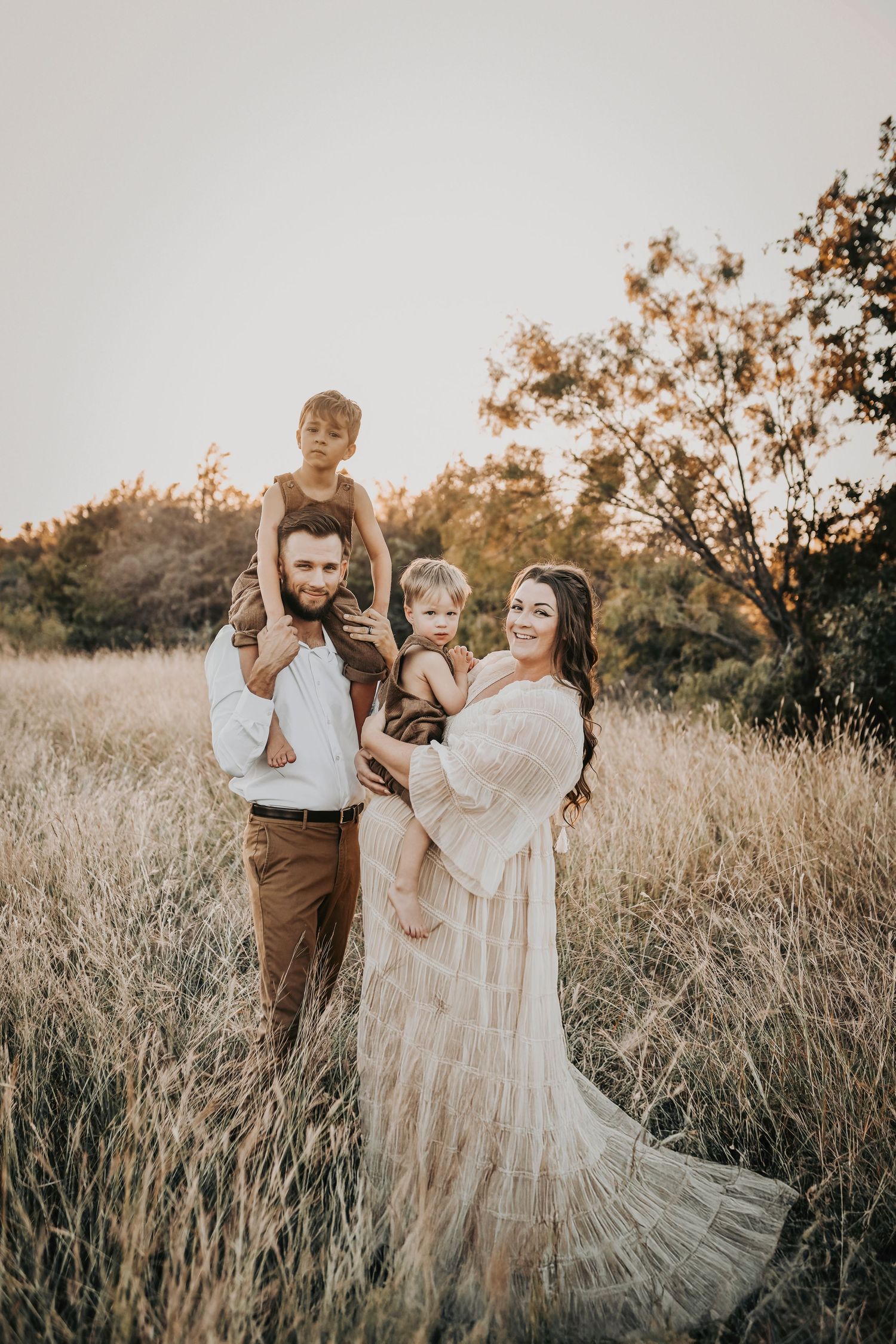 Earthy family maternity photos with an expecting mother in a flowing neutral maternity gown