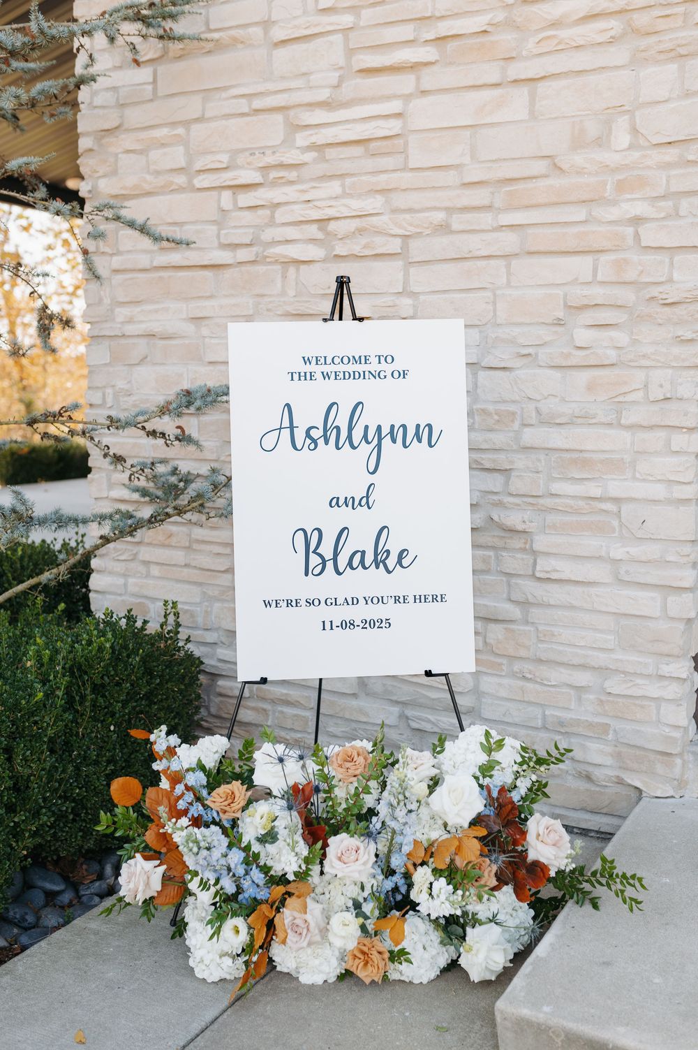 Wedding welcome sign for Ashlynn and Blake on November 8, 2025, adorned with floral arrangements.