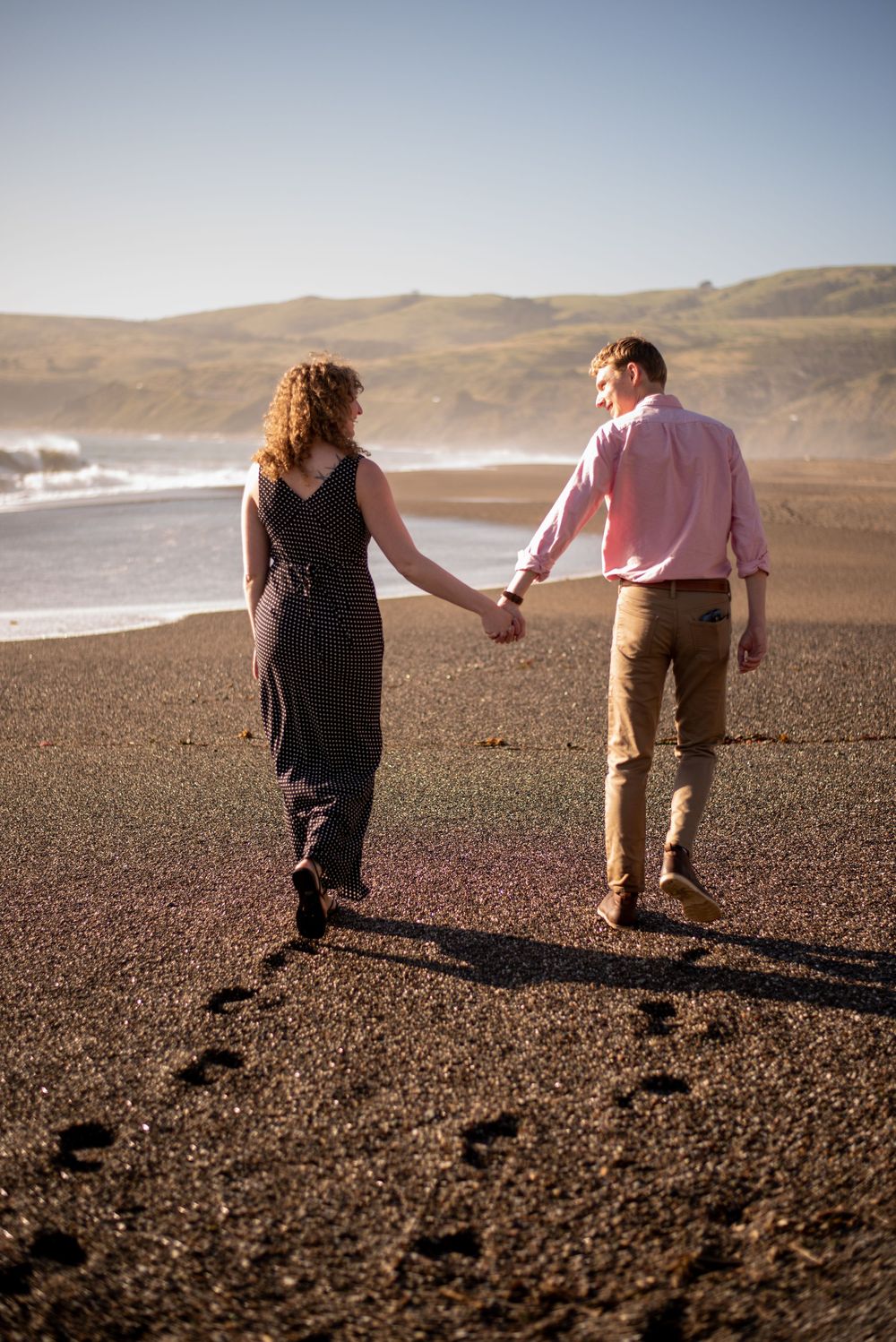 Cinematic Sonoma Coast engagement photography capturing genuine connection, crashing waves, rugged cliffs, and two people completely in love