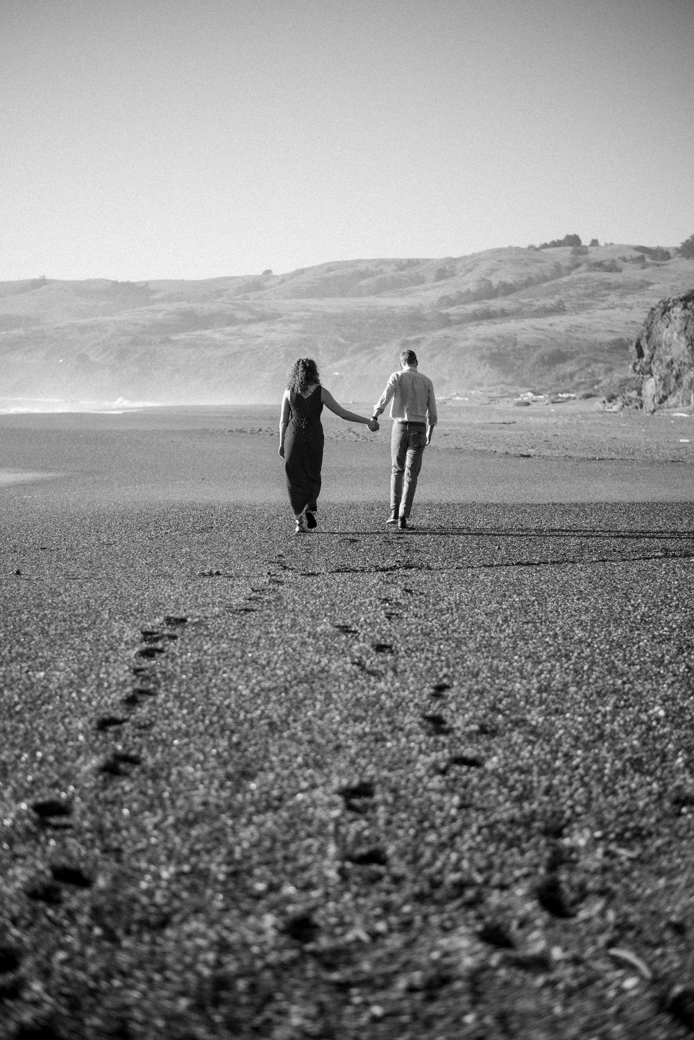 Cinematic Sonoma Coast engagement photography capturing genuine connection, crashing waves, rugged cliffs, and two people completely in love