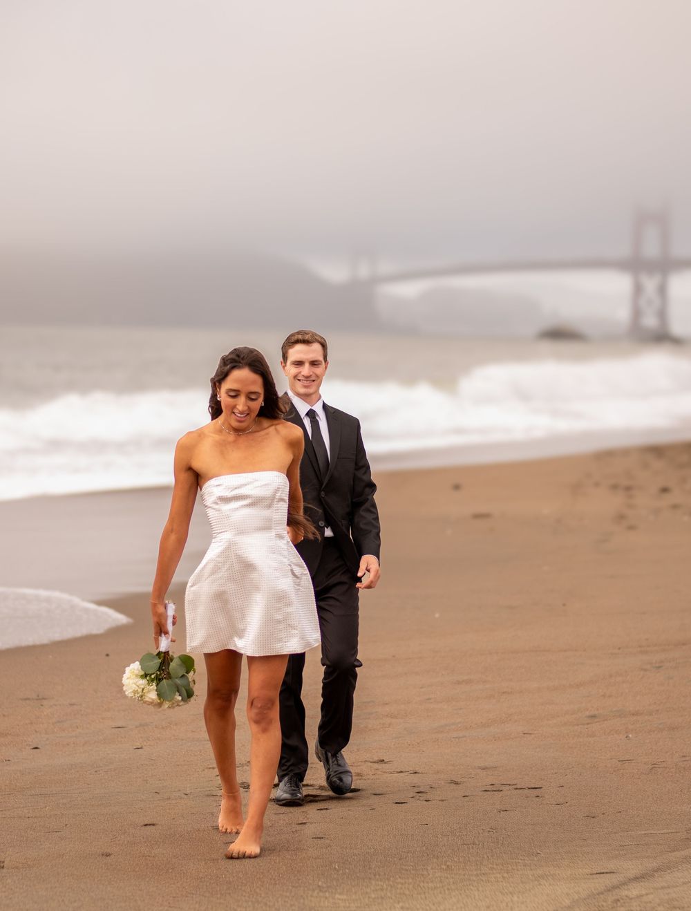 Romantic beach elopement with the Golden Gate Bridge in the background, capturing an intimate, cinematic moment filled with love + adventure