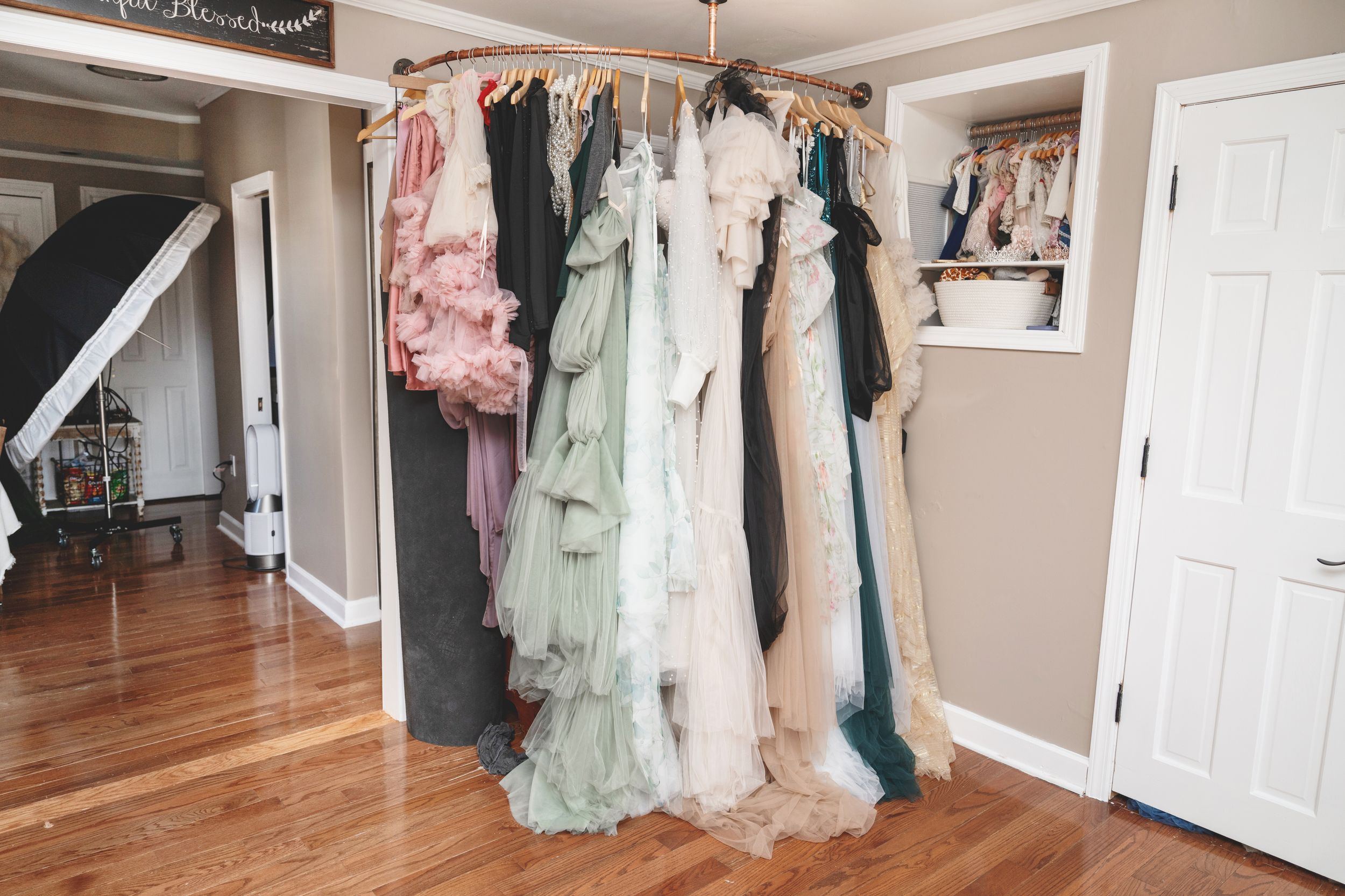 Interior of a private photography studio in Linden, New Jersey with client wardrobe, props, and newborn styling pieces.