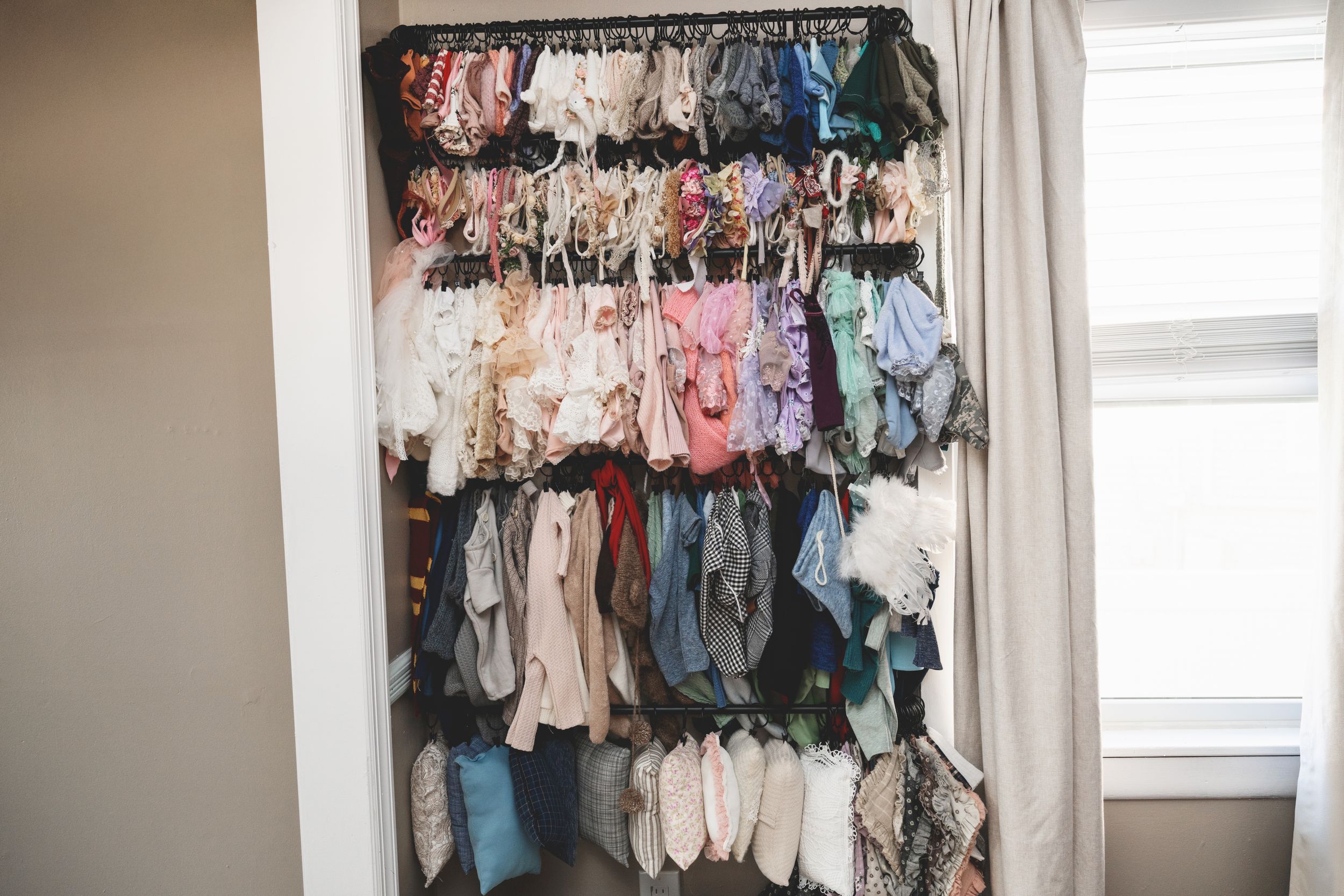 Interior of a private photography studio in Linden, New Jersey with client wardrobe, props, and newborn styling pieces.