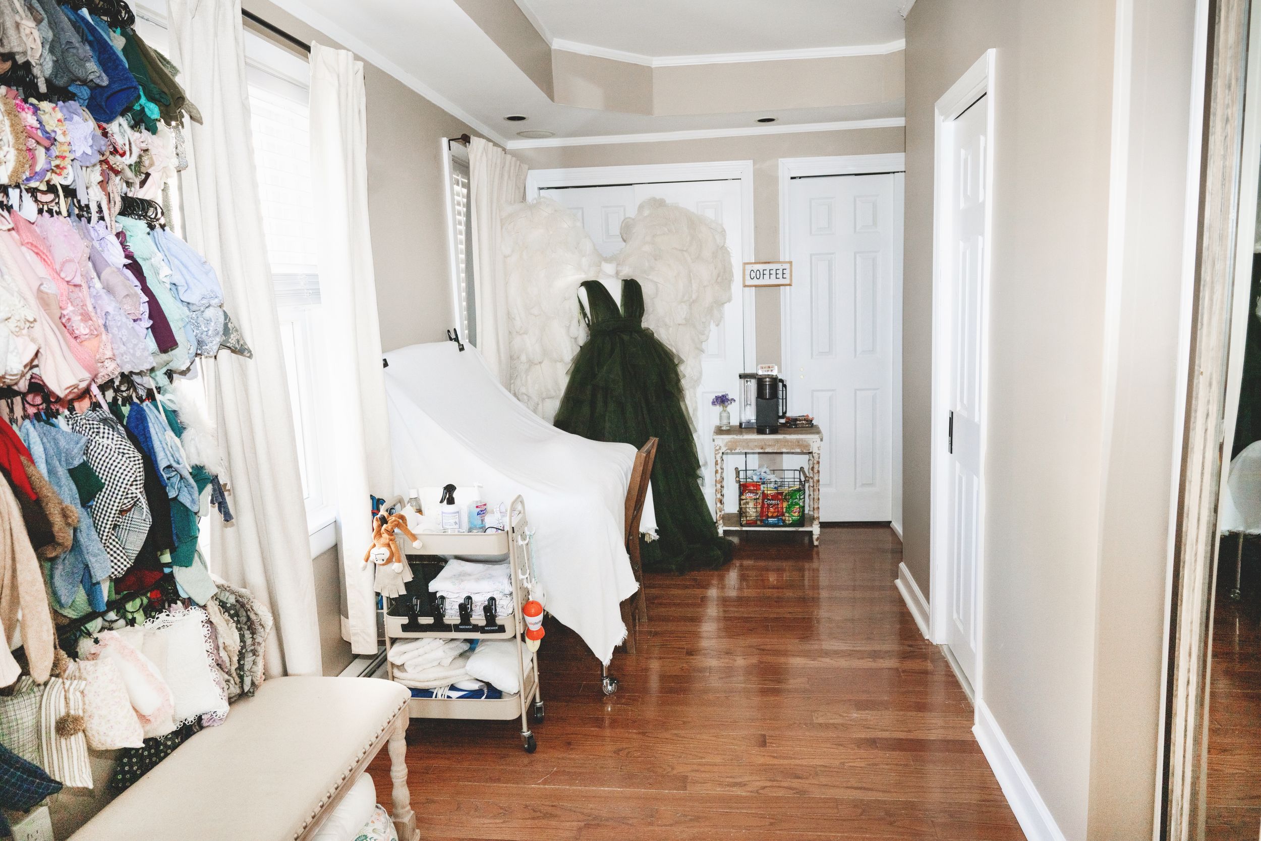 Interior of a private photography studio in Linden, New Jersey with client wardrobe, props, and newborn styling pieces.