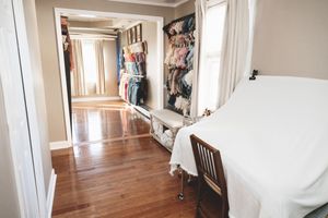 Interior of a private photography studio in Linden, New Jersey with client wardrobe, props, and newborn styling pieces.