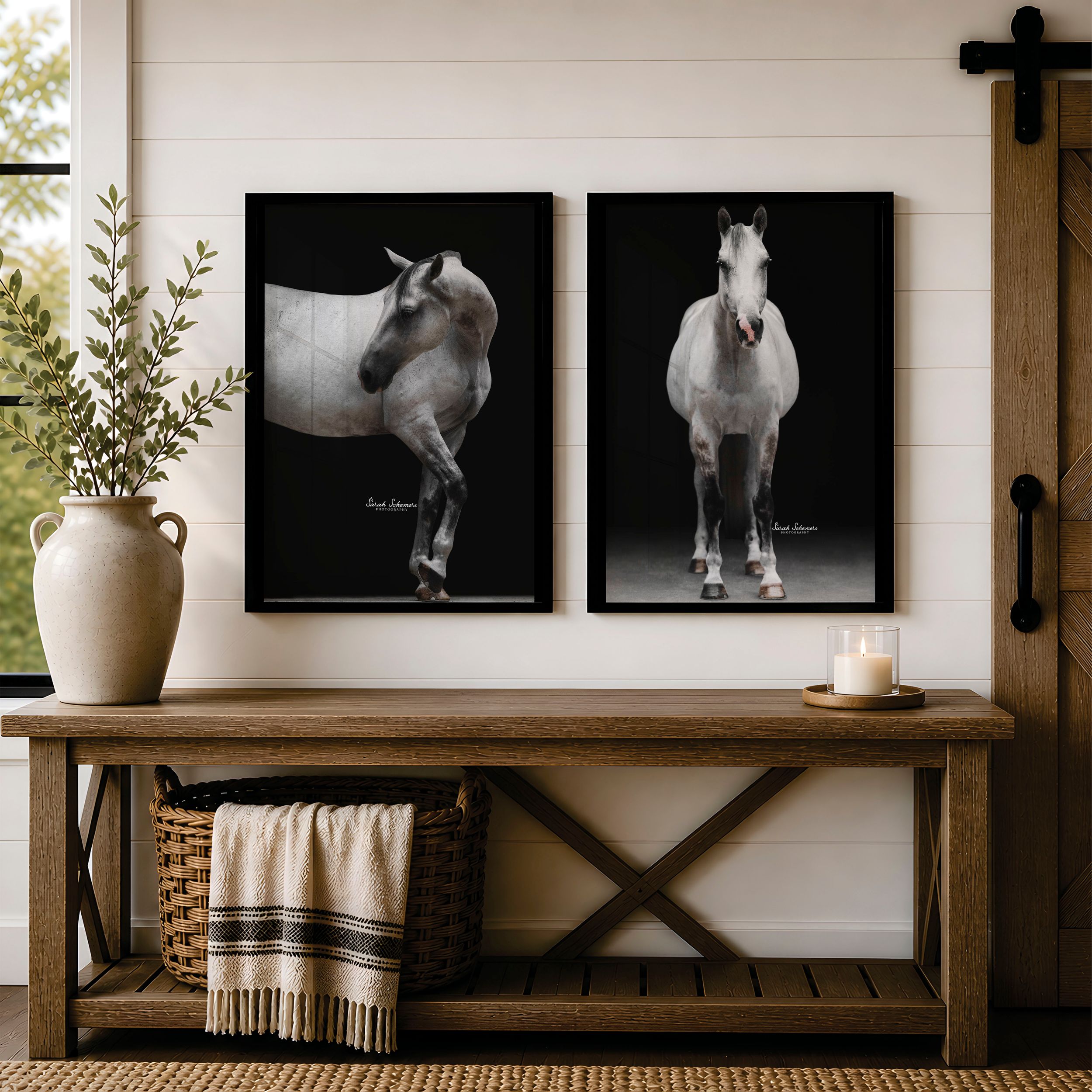 Two framed black and white horse photography prints displayed above a rustic wooden bench in a farmhouse entryway.