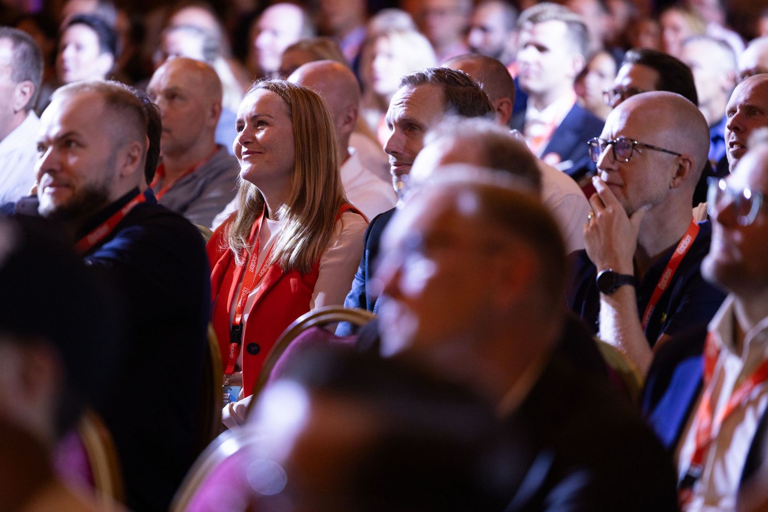 Large conference audience engaged in a presentation at a professional business event.