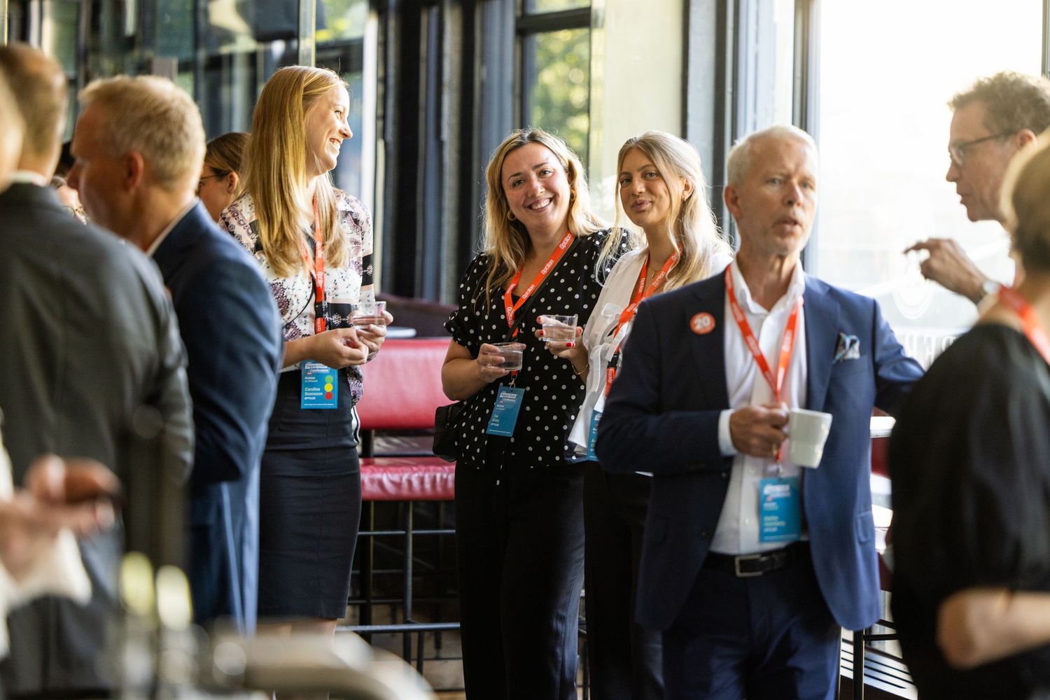 Business professionals networking and socializing at a corporate event reception.