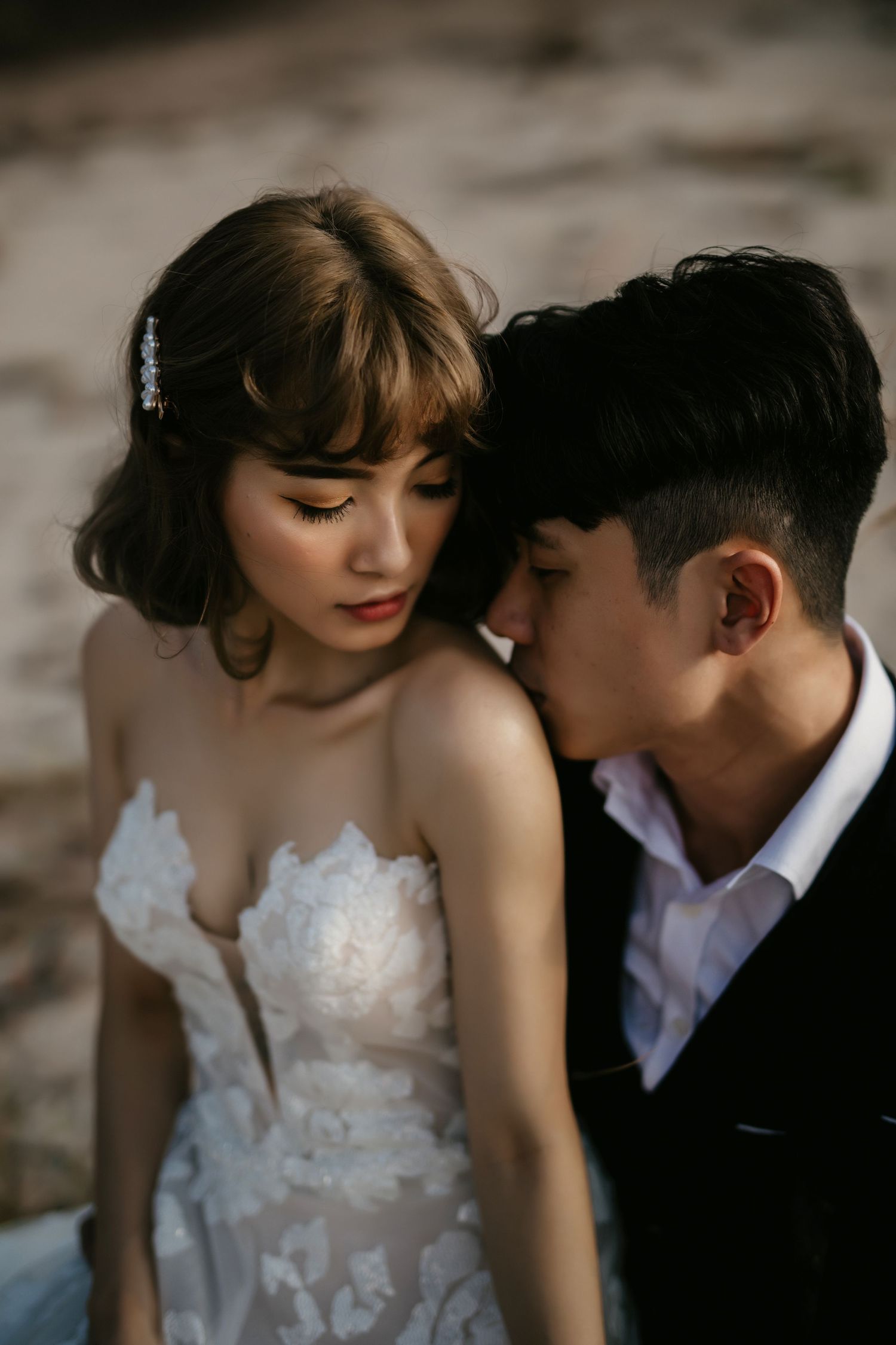 An intimate close-up wedding portrait showing delicate lace details and tender moments.
