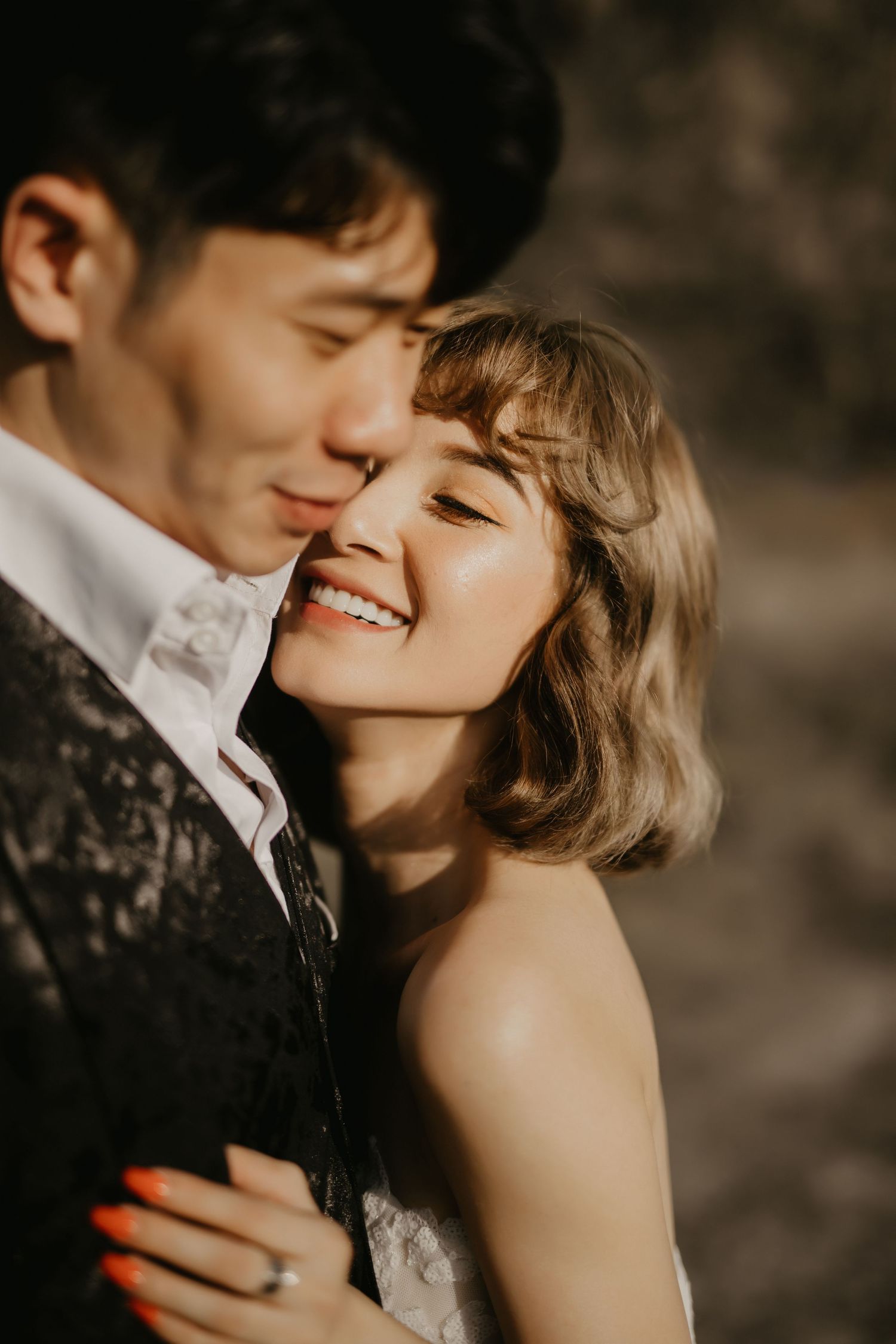 An intimate close-up portrait of a couple sharing a joyful moment.