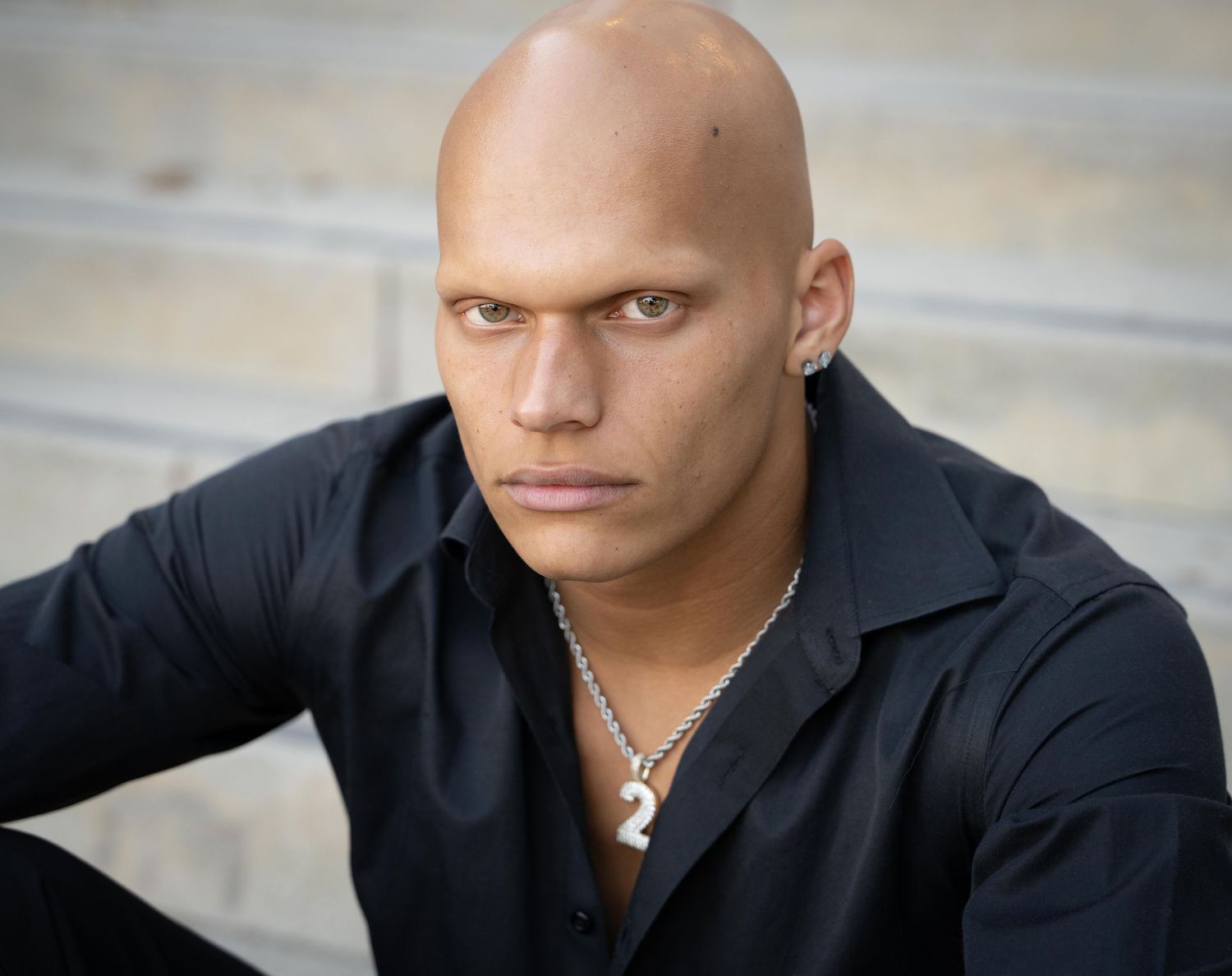 A series of headshots showing someone in a black shirt against a light background.