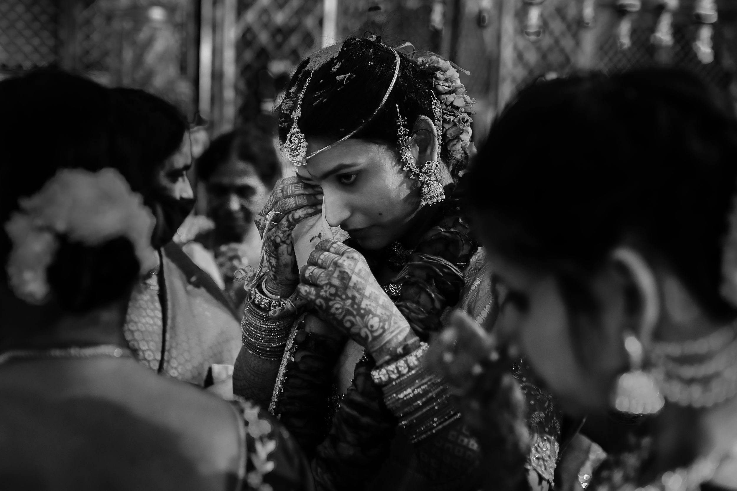 Black and white portrait capturing an emotional moment during traditional Indian wedding ceremonies.