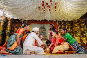 Traditional Indian wedding ceremony with guests gathered around for ritual celebrations.