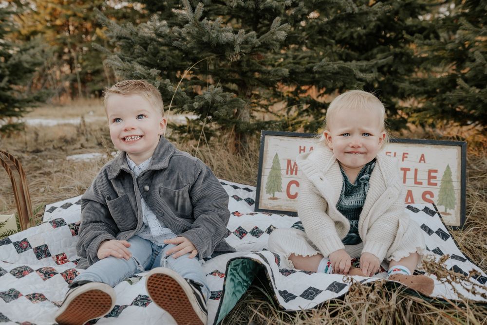 A collection of outdoor family photo session images showing playful moments on a black and white patterned blanket.