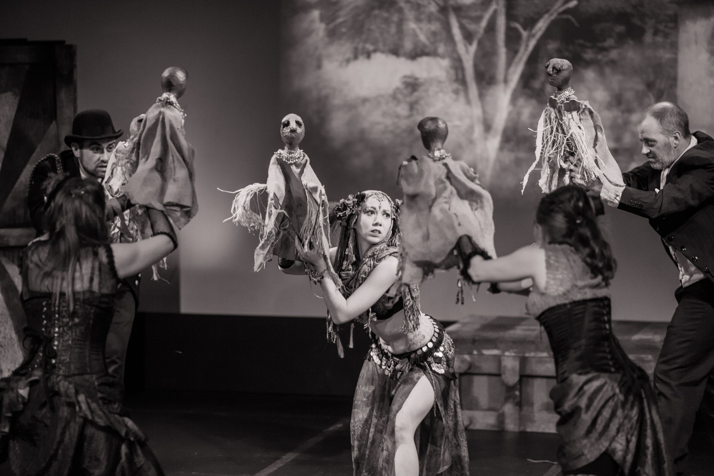 Dancers perform in steampunk-inspired costumes during theatrical stage production.