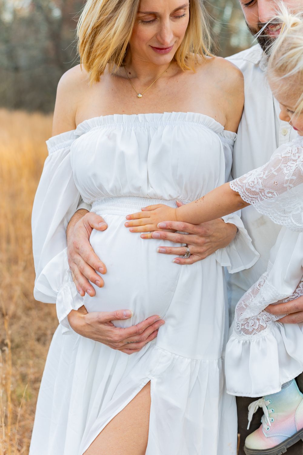 Modern maternity portrait style photo in autumn field in Sudbury, MA in the Metrowest of Massachusetts with family