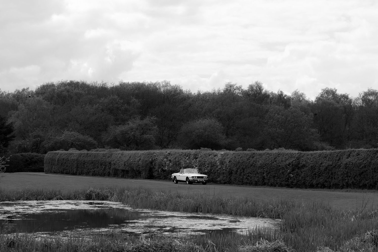 vintage wedding car driving bride at the hidden oak north east wedding venue