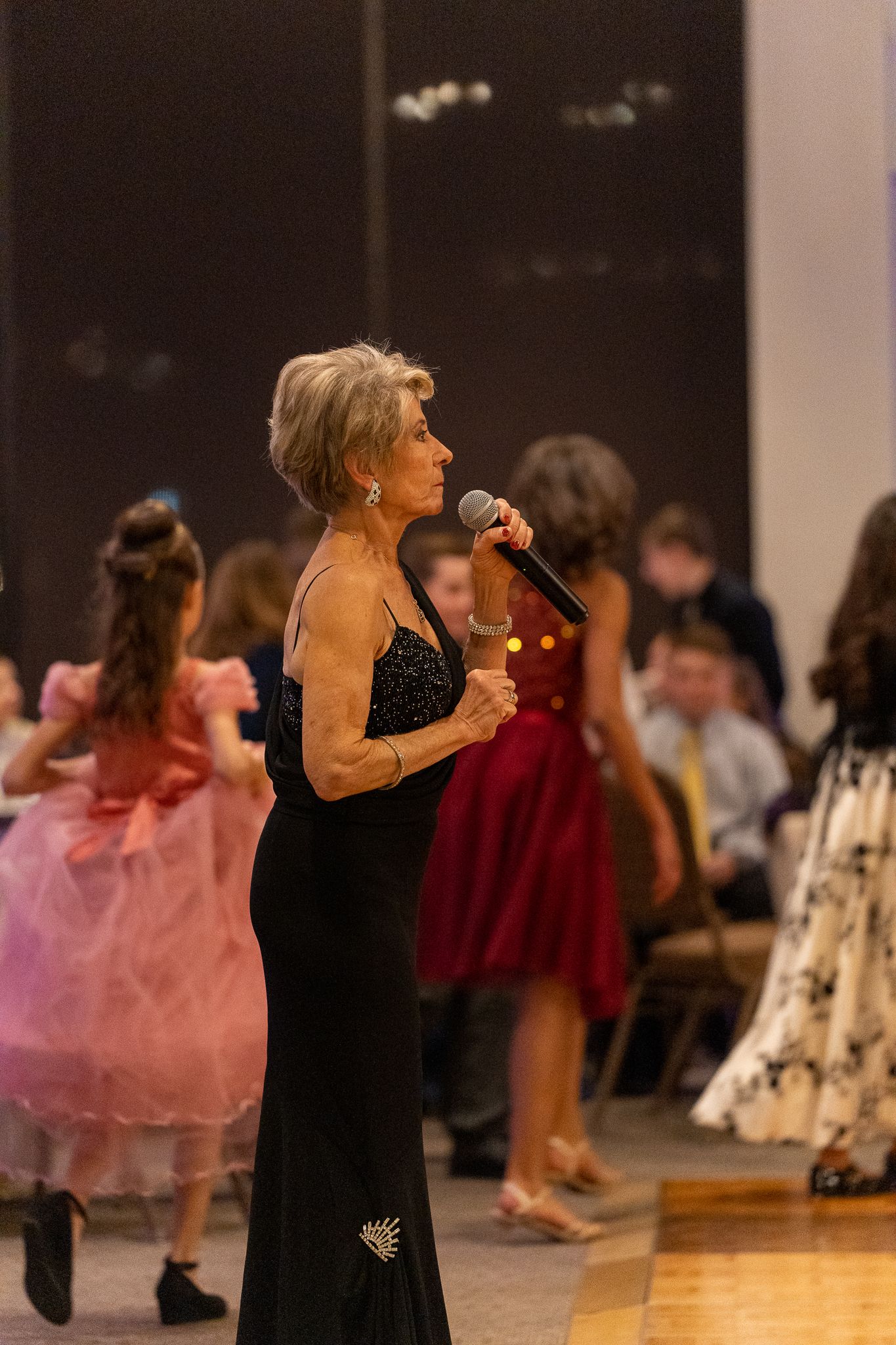 Ballroom etiquette company photography highlighting elegant dancers practicing and performing together.