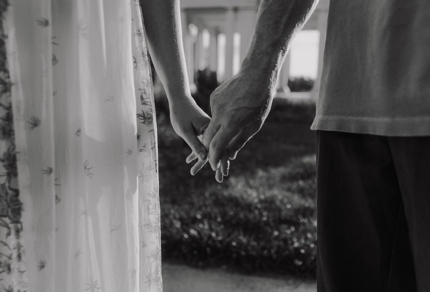 intimate moment of hand holding between a newly engaged couple
