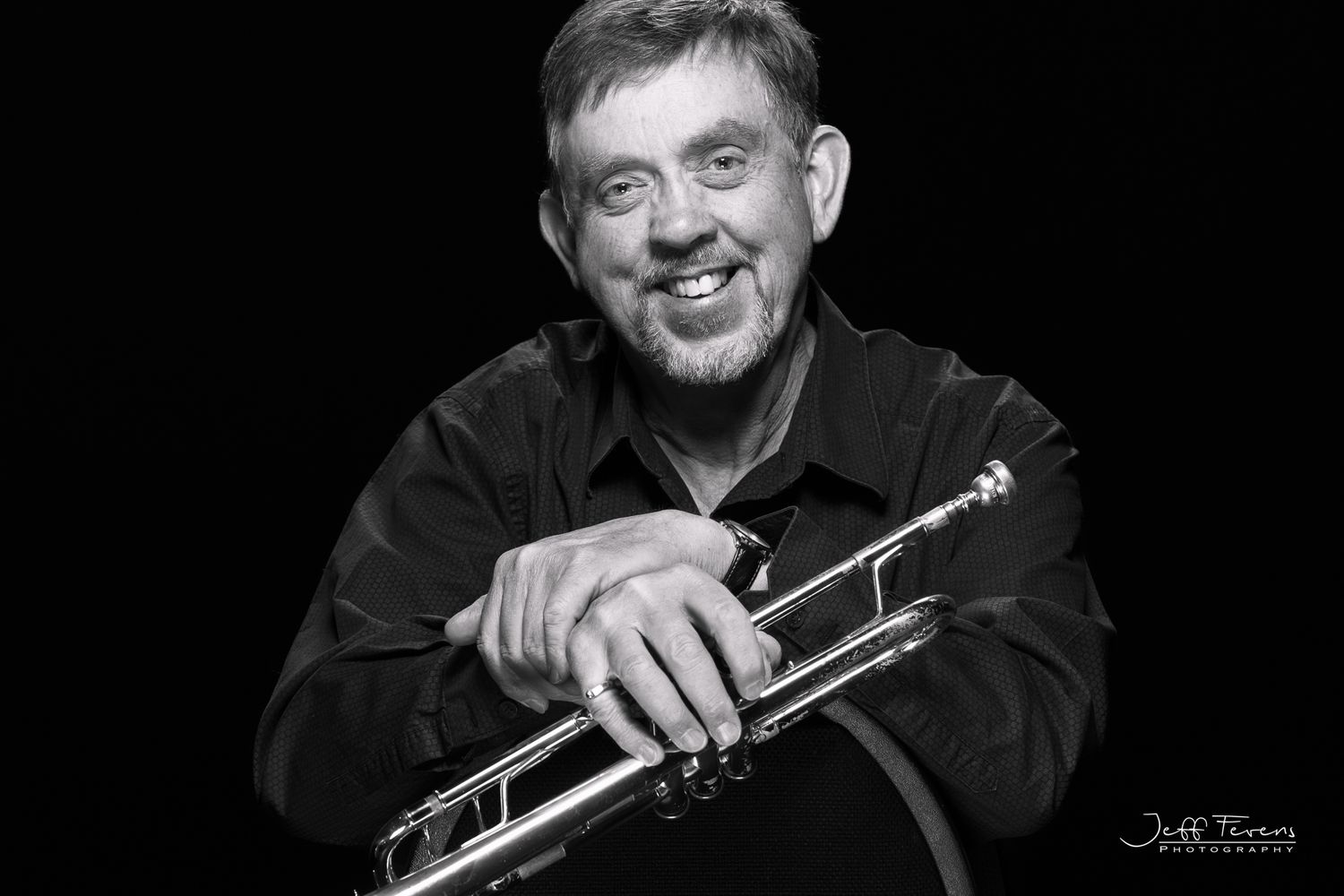 Black and White Headshot of a male trumpet player.