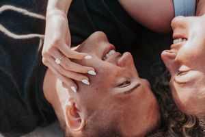 Close-up of couple sharing intimate moment on beach.