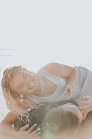 Sunlit beach portrait showing intimate connection between couple.