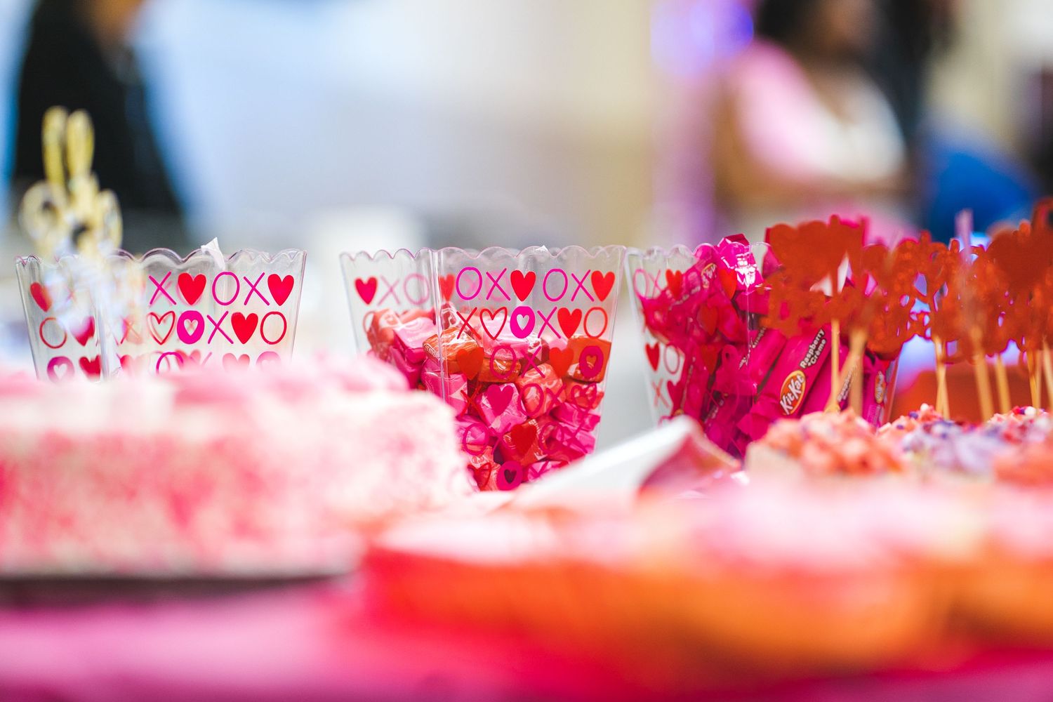 Close-up of pink and red Valentine's Day themed glasses and party decorations.