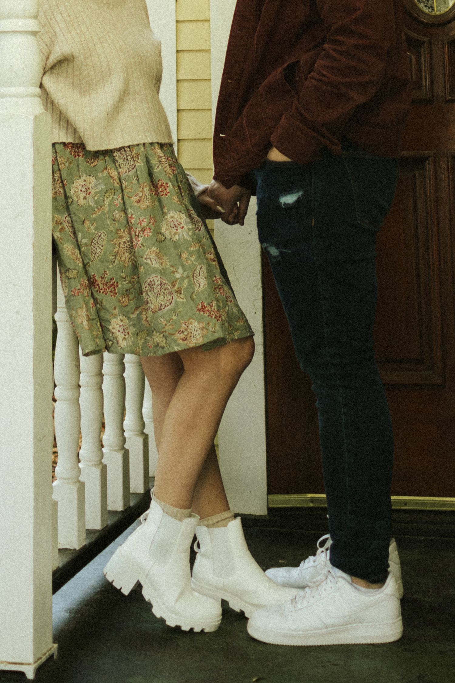 A close up of two women's feet with their hands holding behind them