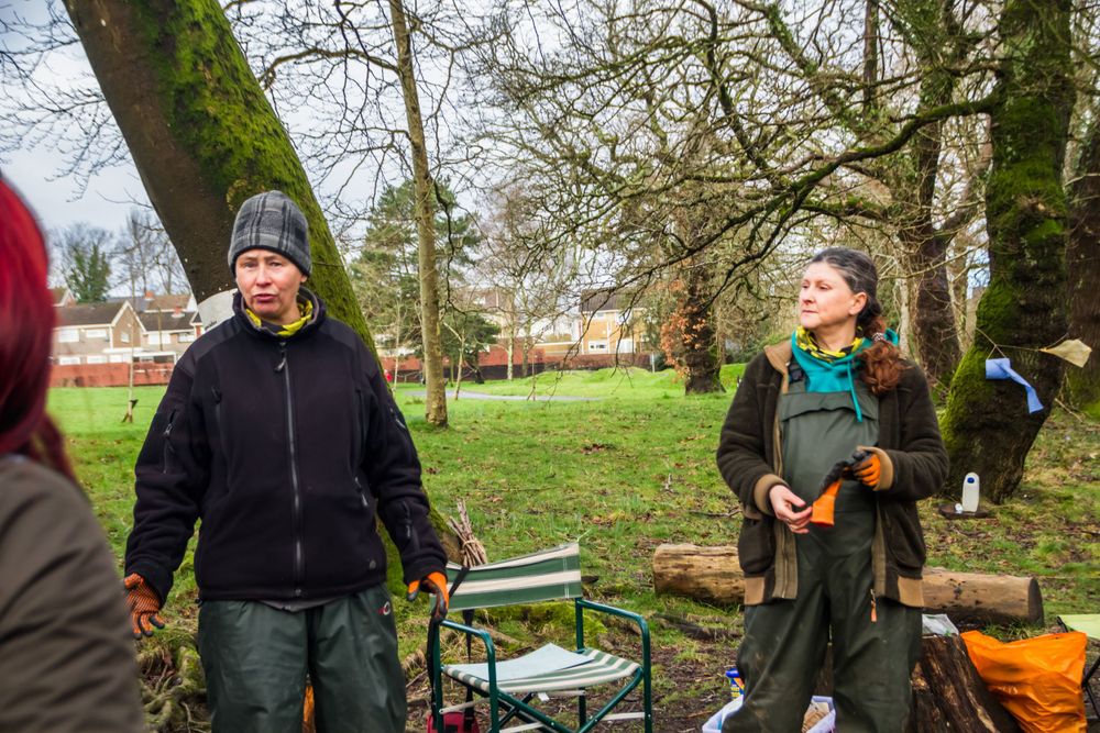 Group gathered outdoors in park setting with equipment.