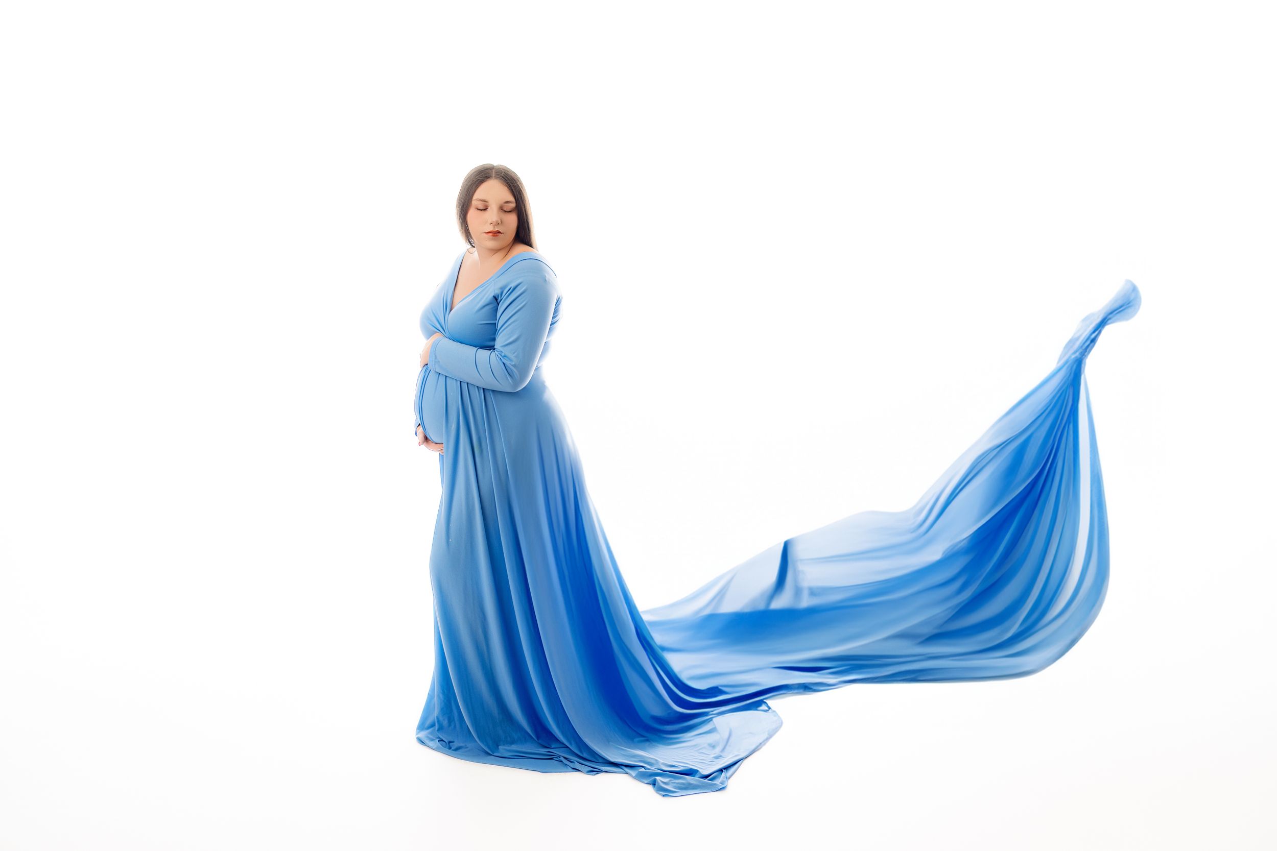 Studio Maternity Portrait in Portsmouth, OH – A glowing mother-to-be poses in a flowing gown against a soft studio backdrop.