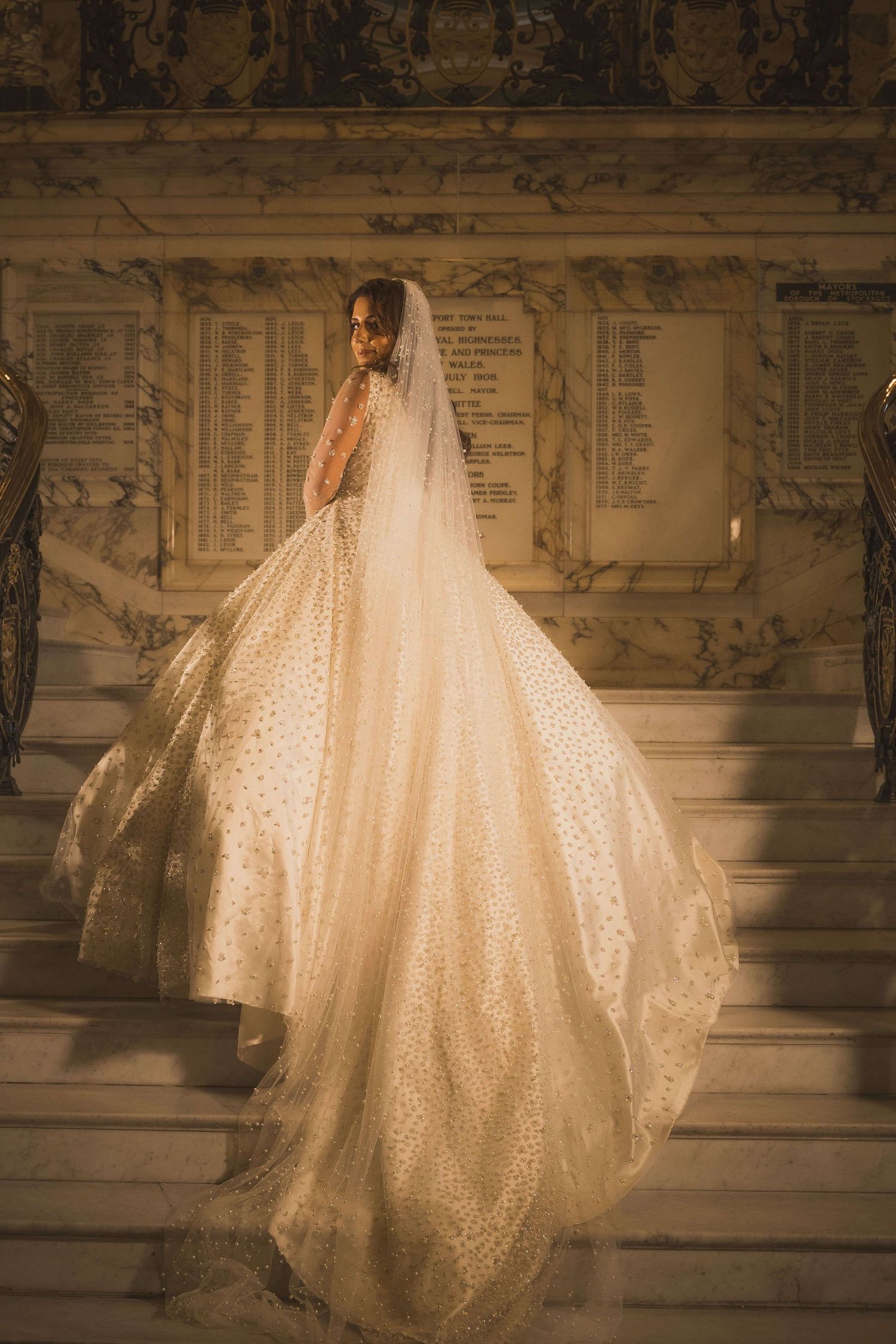 Gorgeous white newly wedded bride walking up the stairs to make her entrance for her wedding