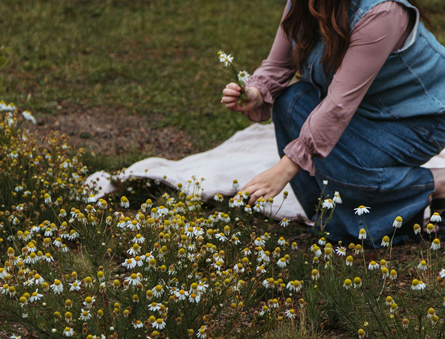 Romantic couple embracing in field of purple wildflowers during photoshoot.