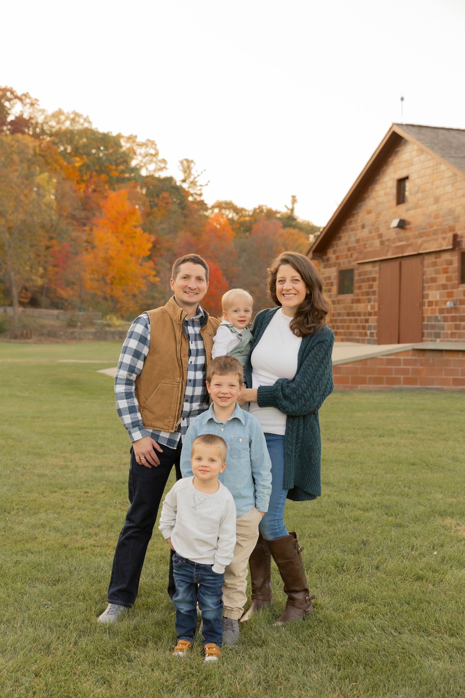 family with 3 boys smiling for a photo at van hoosen farms in rochester michigan