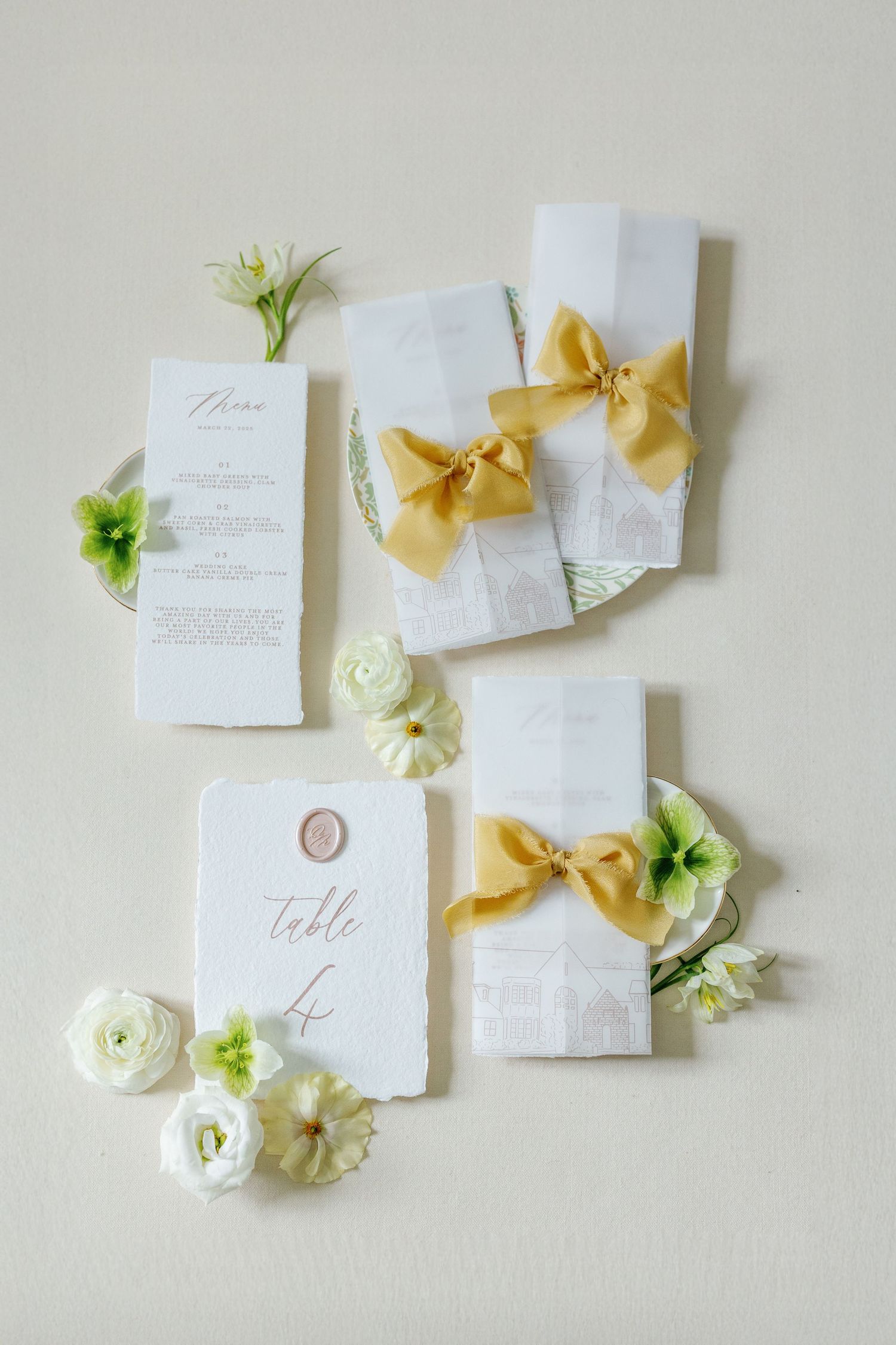 Black and white photo of white bow shoes with Valentino perfume and invitation card.