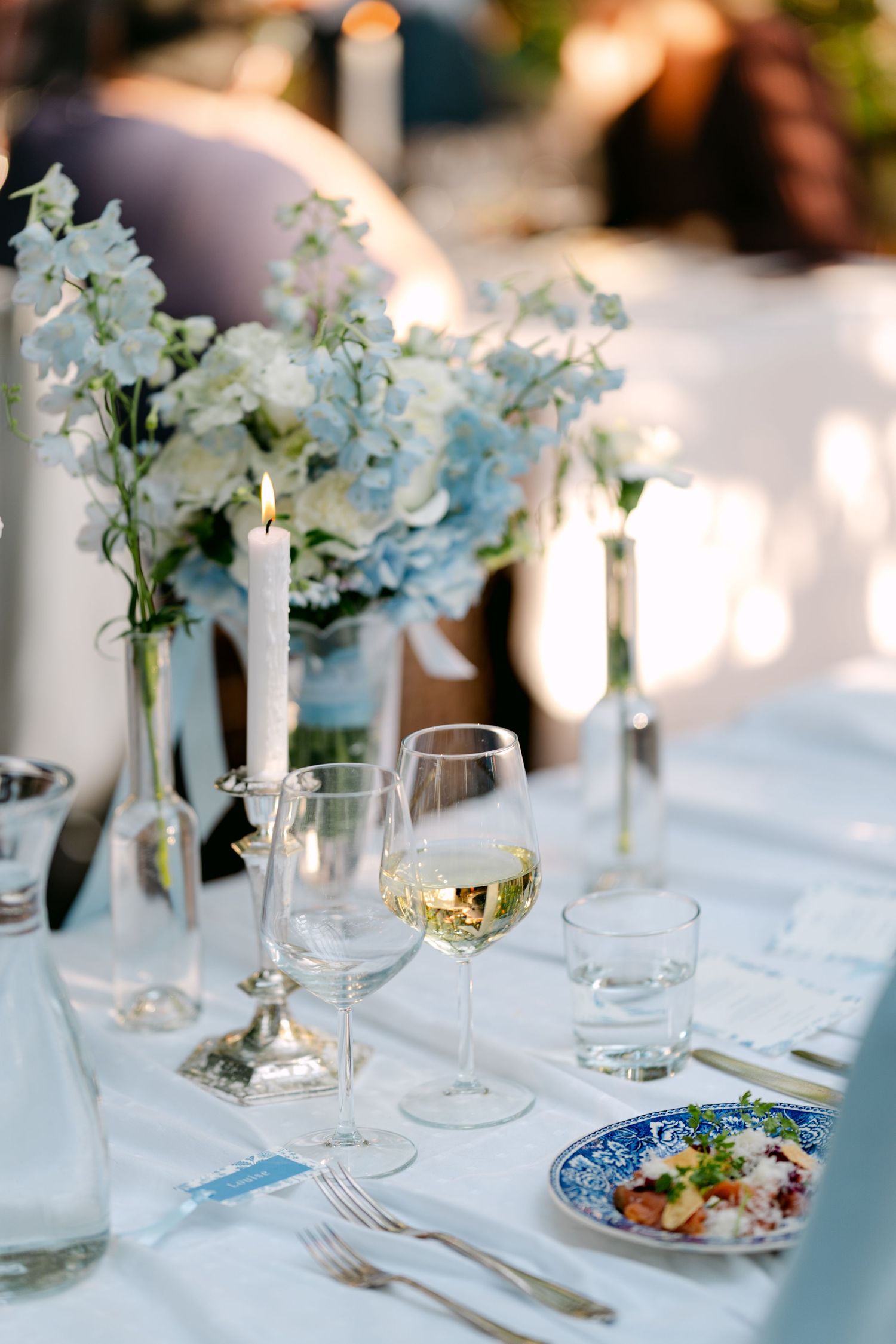 A close-up view of wedding attire and footwear on rustic stone steps with flowers nearby.