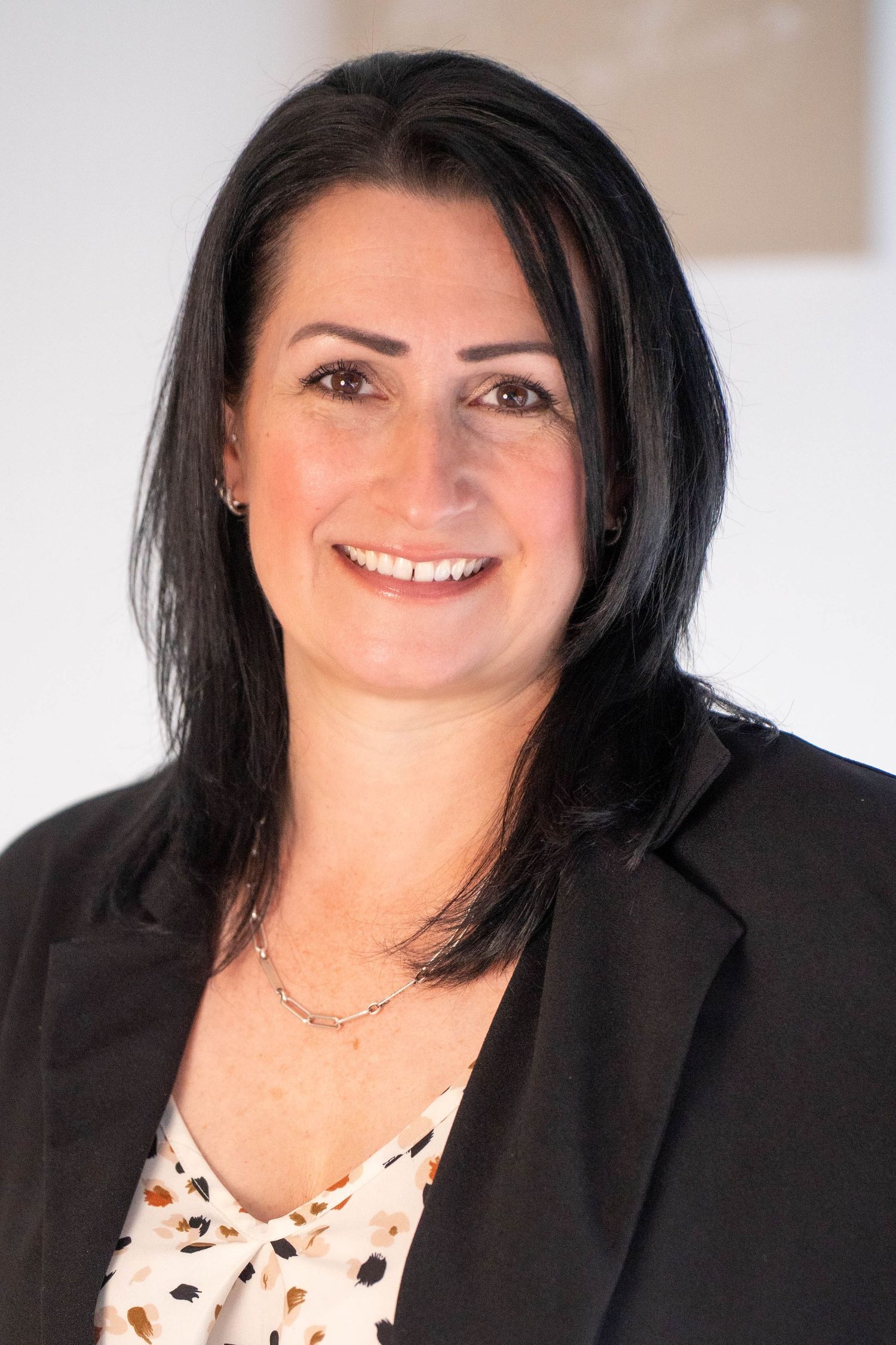 Professional headshot series showing different poses in business attire.