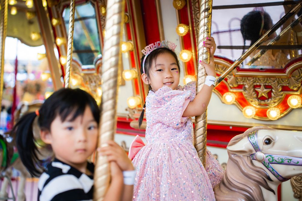 Fun girls birthday party photography on amusement rides at Rainbows End Auckland, captured by Imagine Image Studio.