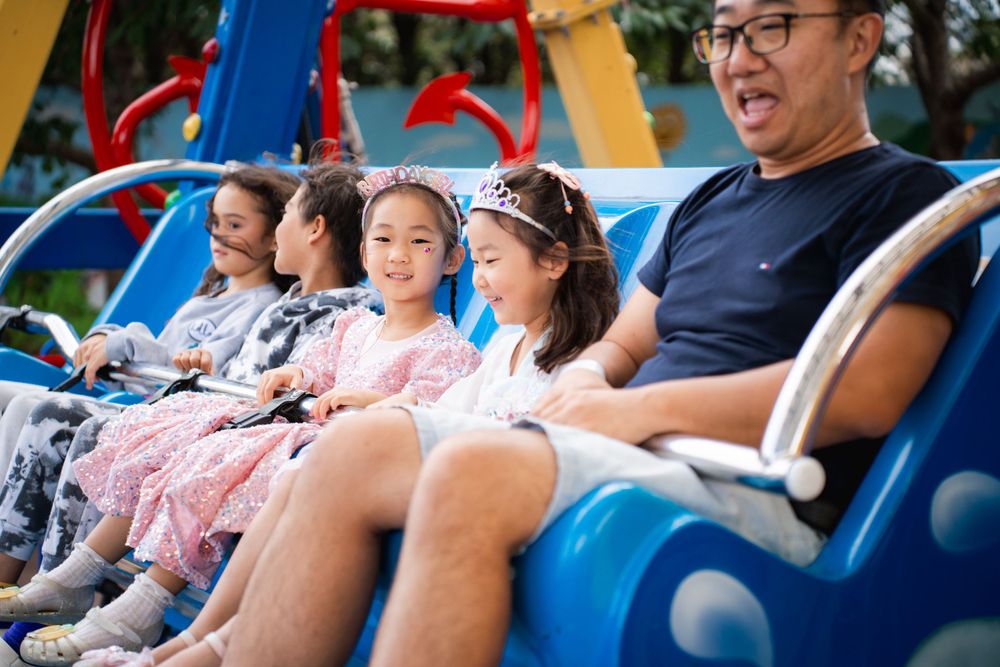 Fun girls birthday party photography on amusement rides at Rainbows End Auckland, captured by Imagine Image Studio.