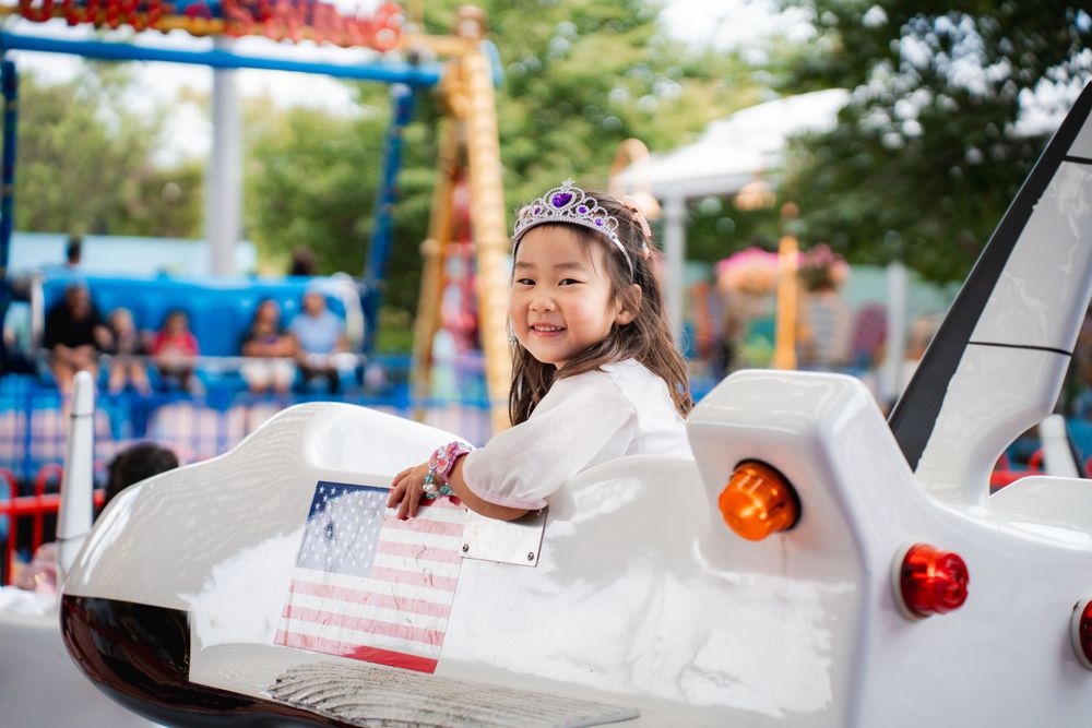 Fun girls birthday party photography on amusement rides at Rainbows End Auckland, captured by Imagine Image Studio.
