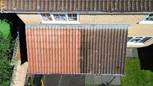 Aerial view of a corrugated metal roof showing weathered rust patterns on industrial or residential building.