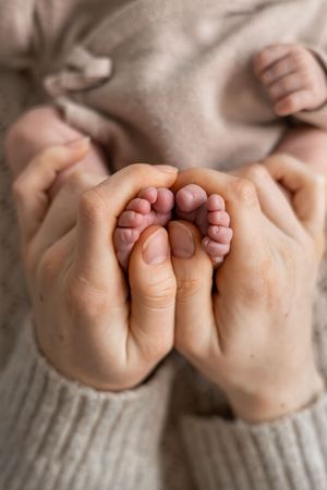 Newborn photography Nottingham baby close up tiny toes and mums hands detail shot