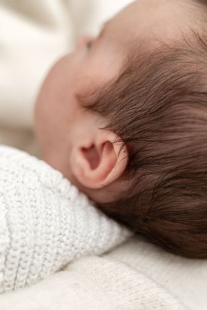Baby photographer Nottingham studio session relaxed newborn photography close up of newborn tiny ear.