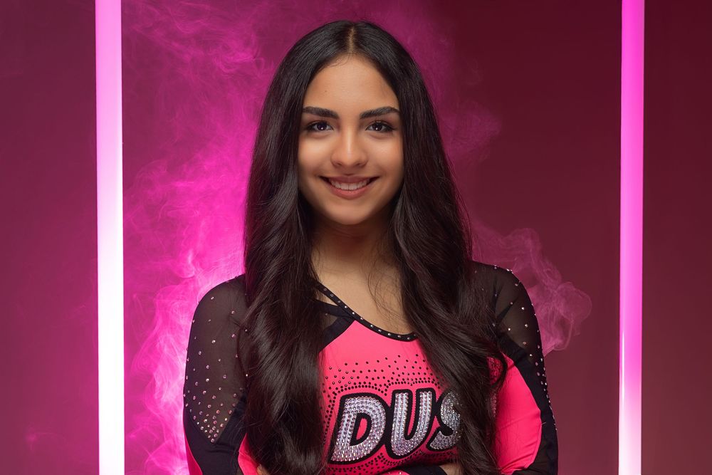A collage of photos showing someone wearing a pink top and dark hair against a magenta background.