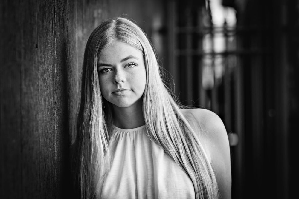 Classic black and white portrait against dark textured background. Grand Rapids Photographer