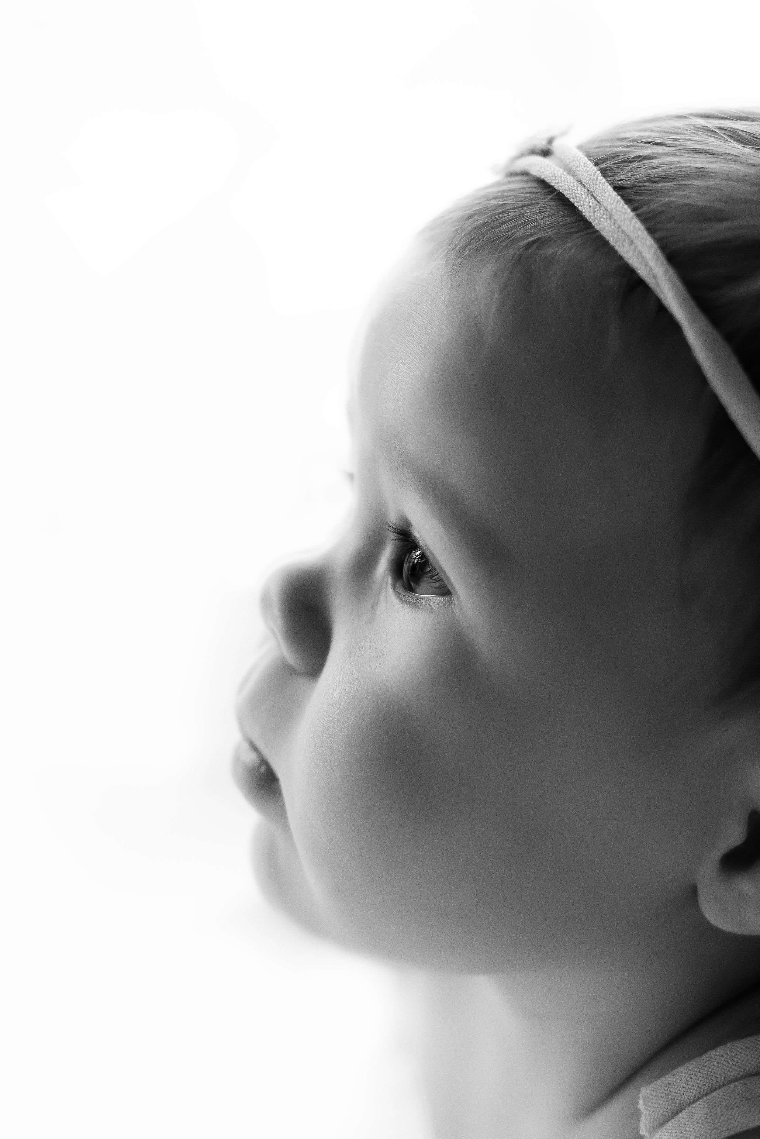 Black and white profile portrait showing soft features of an infant.