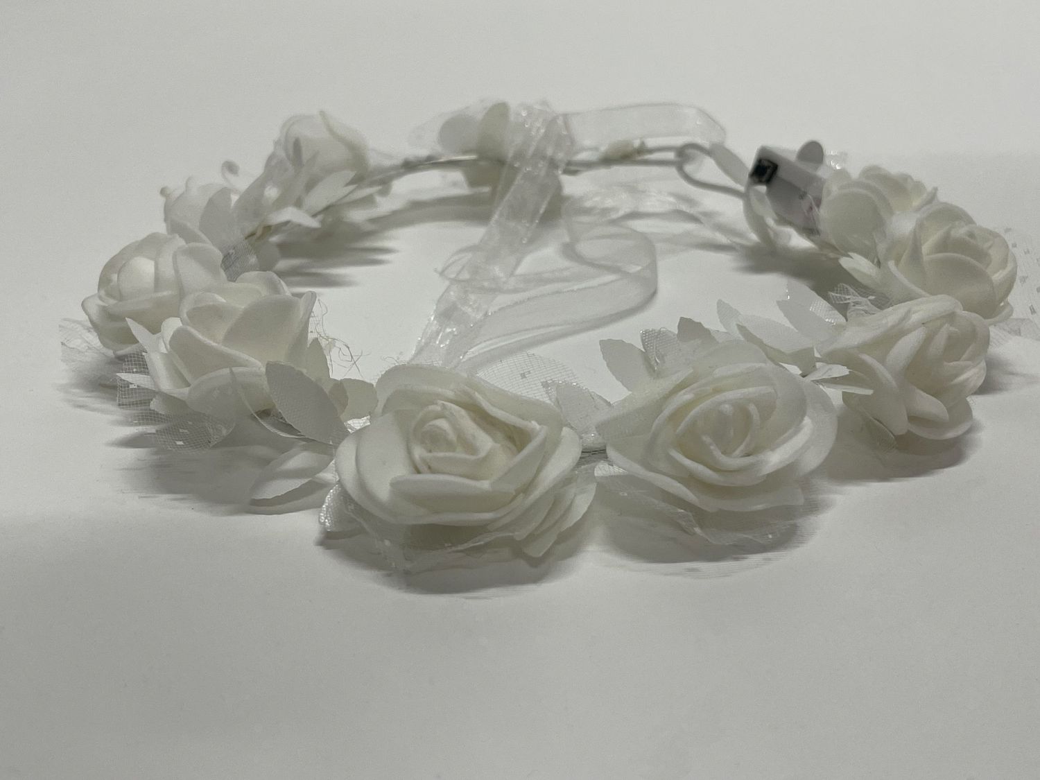 Elegant white rose crown with multiple blooms arranged in a circular pattern.