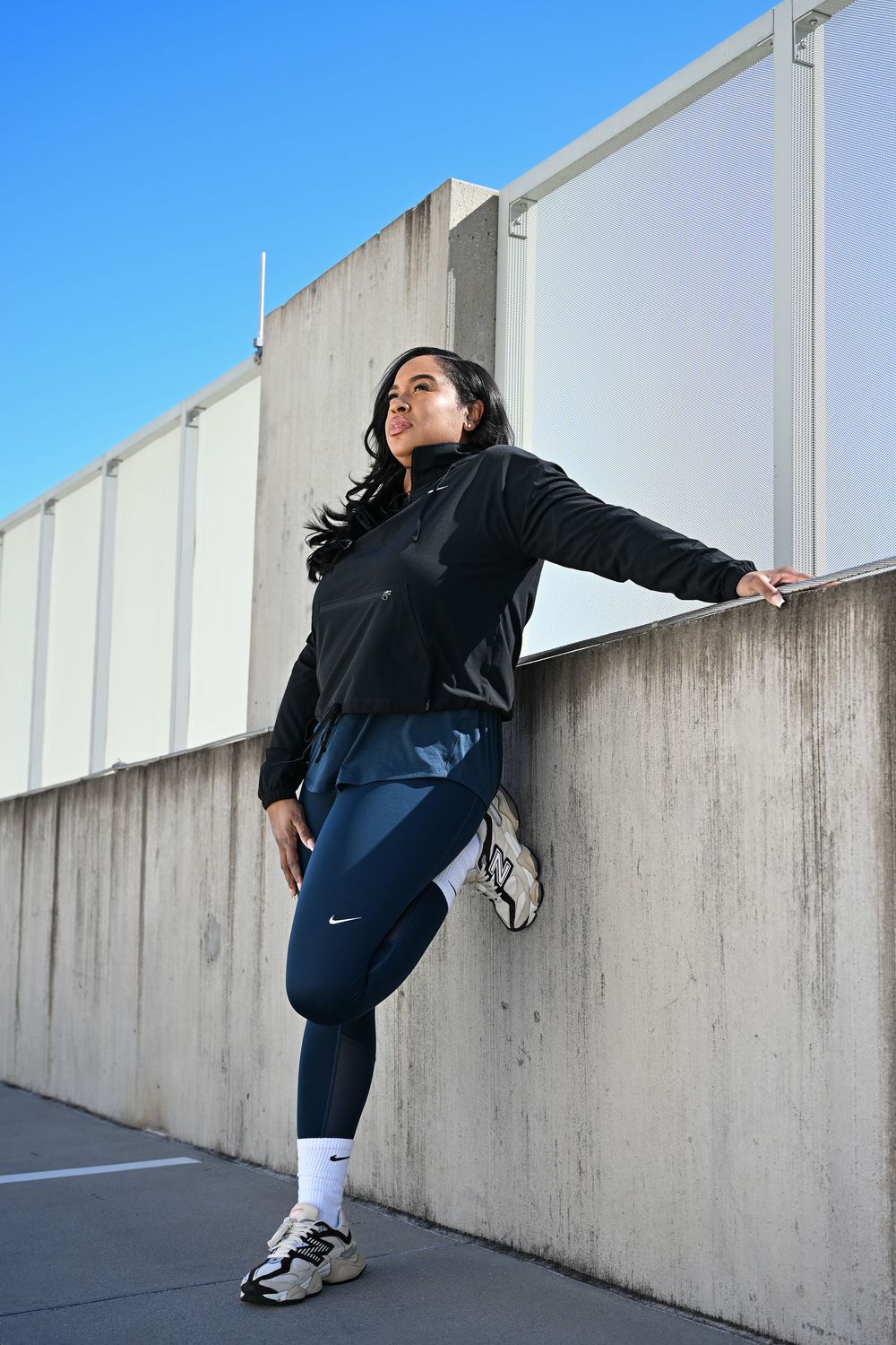 A series of photos showing someone climbing over a concrete wall in an urban setting.